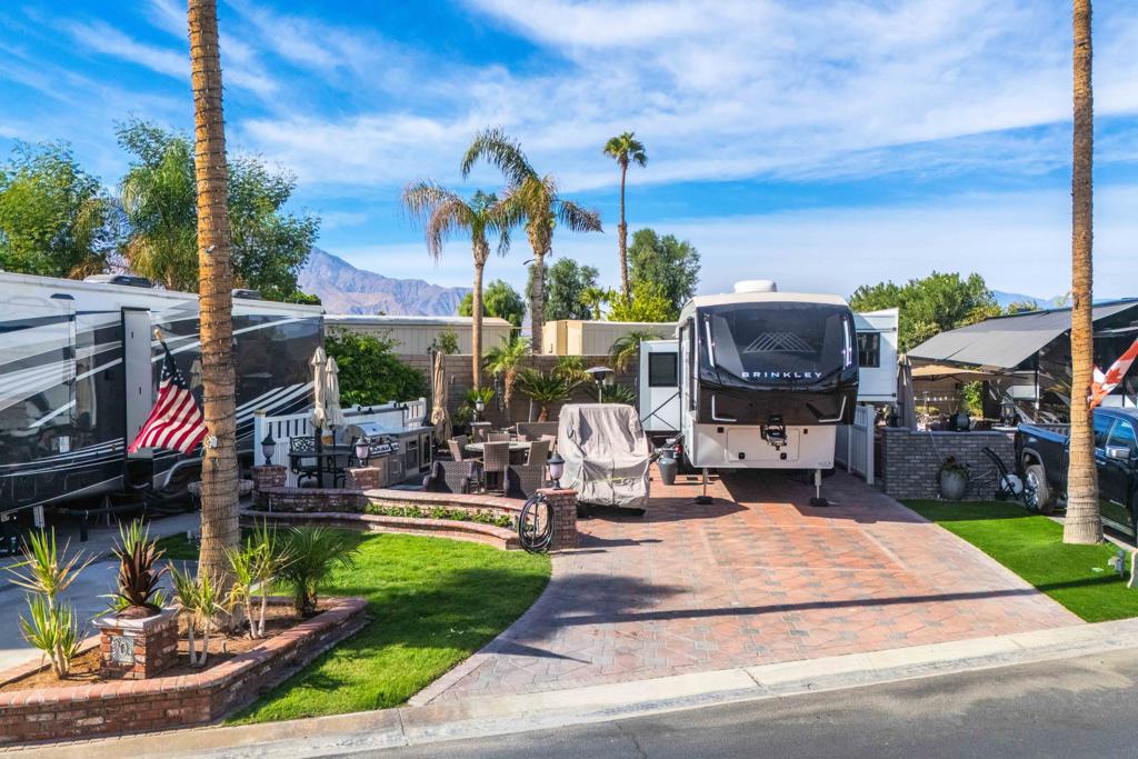 This superb, fully expanded wall lot is ideal for entertaining. It features a beautifully designed outdoor kitchen with a BBQ, gas range, oven, and refrigerator. High-end patio furniture and umbrellas are included, creating a move-in-ready, stylish outdoor setup that's ready to enjoy! Outdoor Resorts Palm Springs is a Five Star RV Resort Community combining luxury with affordability. It is a guard gated resort that sits on 137 beautifully landscaped acres with 27 holes of executive golf, 10 tennis courts, 13 pickleball courts, 8 swimming pools, a fully equipped fitness center. beauty salon/barber shop, full-service restaurant. convenience store. 2 club houses, activities, special events and so much more.