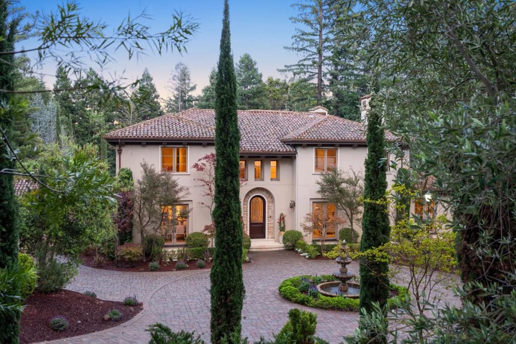 Discover the timeless elegance of 377 Stockbridge Avenue, a Mediterranean-inspired estate where a 5 Bed, 5.5 Bath main residence and separate 1 Bed, 1 Bath guest house are united by a floorplan tailored for both formal occasions and casual living. The first impression is made through a stunning two-story foyer. To the right, a formal living room with dual-sided fireplace leads to a spacious home office and a ground-floor bedroom suite. To the left, an expansive dining room sets the stage for memorable gatherings. Beyond, the kitchen and light-filled breakfast nook feature custom cabinetry, stone countertops, and professional-grade appliances. An informal living room plus a recreation lounge with an old-world-style wine room and wet bar complete the main level. Upstairs, the primary suite offers a fireplace, dual closets, and a spa-inspired bath, accompanied by three additional spacious en-suite bedrooms and a laundry room. Ideal for multi-generational living, guests, or staff, the guest house offers a kitchen, dining nook, and living room. Enjoy quintessential California outdoor living on the terrace with a built-in kitchen, fireplace, and multiple seating areas overlooking beautifully landscaped gardens. All just minutes from downtown Menlo Park and Palo Alto.
