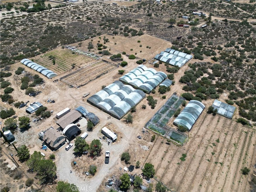 Own a home that pays for itself! This active, income-producing farm lets you enjoy country living while the land works for you. Live the lifestyle you’ve dreamed of, your home, your income—this farm helps offset living costs. Private 21.48-Acre Current Working Farm with Home, Greenhouses & Mountain Views! Versatile agricultural property featuring about 20,000 sq ft of Hydroponic ponds, currently producing Asian Celery and 35,000 sq ft of outdoor crop field, fully fenced in and has drip lines,  Plus much potential for Ong choy, yam leaves and other field crops.

The interior of Home is a work in progress and awaits your finishing touches 3 bed, 2 bath, 1,248 SqFt two-story home with a full kitchen, deck, guest quarters, and attached 2-car garage. Ideal for farming, ranching, or equestrian use, the land is fully fenced, cross-fenced, and entirely usable.

Includes 9 Greenhouses ( 28,000 SqFt) and 2 Greenhouses (4,800 SqFt) with automated sprinklers, 5 additional in-progress greenhouses (12,000 SqFt), 20,000 SqFt of hydroponic ponds, and 35,000 SqFt of fenced outdoor crop field with drip irrigation a full water/fertilizer distribution system. Powered by 2 private wells, 4 water tanks with a Well-X-Trol pre-pressurized well tank with a septic tank for a 3000 square foot home. Property is completely xeriscaped with water-saving low drip irrigation system. Mobile unit on-site for caretaker use. Zoned for growth with no water bill and ample opportunity!

Enjoy peaceful country living with panoramic views, just minutes from local shops and services.

Sustainable living with income that supports your home.