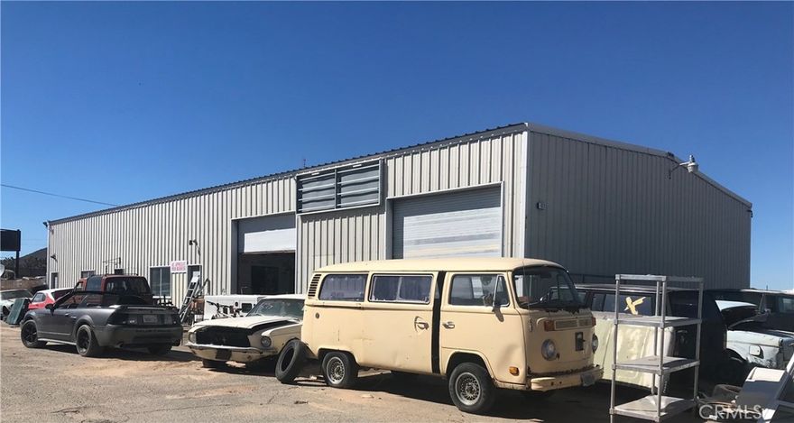 Prime Investment Opportunity! This remarkable property presents a 2.3-acre lot with prominent exposure on the bustling Old Woman Springs Road (Hwy 247) at Buena Vista. Boasting a 5000 sq ft metal building, this versatile space is currently configured as an efficient auto repair shop. Equipped with 4 lifts, it facilitates seamless operations for automotive enthusiasts. Above the shop, a comfortable 2-bedroom, one-bathroom apartment provides convenient on-site living quarters. Additional offices and a bathroom on the main level offer added convenience for business operations. The building's high overhead doors and lofty ceiling height accommodate large trucks and foster versatility. In the process of removing several antique cars from the lot, the property is being prepared for a fresh start. Complete fencing envelops the entire premises, ensuring security and privacy. The land is zoned Neighborhood Commercial, opening the door to a multitude of business possibilities. City water and a septic system , providing essential utilities. Don't miss out on this exceptional opportunity to capitalize on the thriving location, the existing infrastructure, and the potential for further development. Seize the chance to make your mark in the commercial real estate landscape with this enticing property.