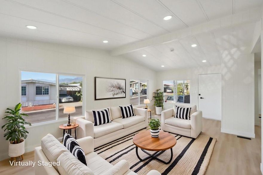 COMPLETE INTERIOR REMODEL! This beautifully reimagined home blends modern upgrades with open, comfortable living. The expanded kitchen and vaulted ceilings create a bright, airy feel that connects seamlessly to the family and dining rooms, perfect for both daily living and entertaining. Luxury vinyl flooring, quartz countertops, stainless steel appliances, energy-efficient windows, and recessed lighting are found throughout.  From the living room and raised front porch, enjoy sweeping Southwestern mountain views. The chef's kitchen flows to a spacious family room with slider access to the front patio, while the dining room offers built-in cabinetry for added storage and display. The primary suite features a spa-inspired bath with shower stall, free-standing soaking tub, and generous vanity space. The laundry room is designed for convenience with a sink and extensive cupboard storage.  Sky's Haven is one of Desert Hot Springs' premier 55+ gated communities, featuring three pools, spa, clubhouse, fitness center, sauna, billiards, and park area, along with a full calendar of social and recreational activities. Best of all, you OWN THE LAND with low HOA dues, and all utilities are billed through the HOA. Ideally located just 15 minutes from Palm Springs and 20 minutes from Morongo Casino Resort & Spa in Cabazon, this home offers both comfort and lifestyle in a highly desirable setting.