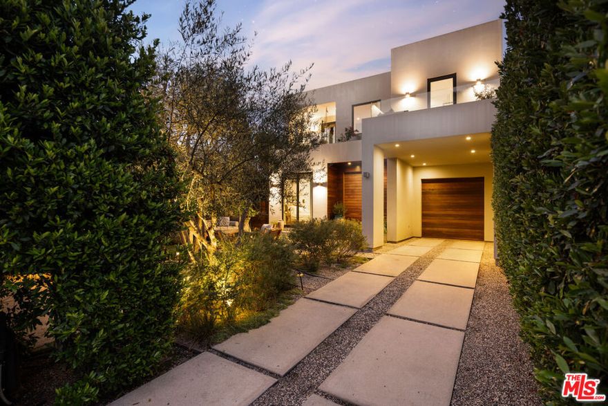 Enveloped in enchanting gardens with mature olive trees and lush potted greenery, this West Hollywood architectural retreat feels like a private sanctuary.  Designed for both entertaining and everyday comfort, the property offers inviting gardens that extend to a sparkling pool and spa framed by sunlit terraces and shaded retreats.  The chef's kitchen is a true showpiece, featuring custom Bulthaup cabinetry, a walk-in pantry, and Gaggenau appliances.  Walls of glass with Fleetwood doors open to expansive terraces, blurring the line between indoor and outdoor living.  Upstairs, the primary suite offers a spa like en suite bath with walk in shower and two private terraces for a true sense of escape.  With three bedrooms plus an office, the layout is flexible and functional.  A one-car garage can easily serve as a gym or creative studio.  Built-in speakers indoors and on the patios create a seamless vibe throughout.  Modern upgrades include a Lutron lighting system, motorized blackout shades, gated entry with Doorbird access, outdoor heaters, and built in barbecue.  Every detail has been curated for comfort, privacy, and style making this home a rare offering in the highly coveted West Hollywood West.