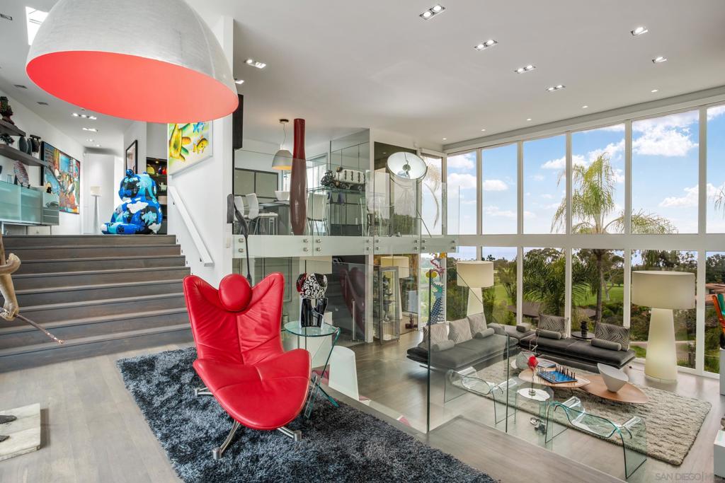 An exquisite summer rental nestled in the exclusive Country Club neighborhood of La Jolla. This modern home has been completely remodeled into an elevated art sanctuary, offering over 4,500 square feet of immaculate living space. Enjoy incredible panoramic views of the Pacific Ocean and the lush fairways of the La Jolla Country Club. Situated above La Jolla Village, this property provides easy access to shopping, dining, golfing, and beautiful beaches, all just minutes away. The prestigious Country Club neighborhood is renowned for its privacy and coastal ambiance. The heart of the home is the Ernestomeda kitchen, equipped with Gaggenau ovens and a Jura espresso maker. The interior is adorned with high-end furniture from Ligne Roset, Montis, Agape, Flexform, B & B Italia, Horm, Ron Arad, and Fiam, ensuring a luxurious and comfortable stay. Spacious and beautifully designed living areas seamlessly blend art and comfort, enhanced by bright natural light and floor-to-ceiling windows. Well-appointed bedrooms with 180-degree stunning views provide restful retreats, home office, while modern, spa-like bathrooms are designed with the finest materials and fixtures. The lower level features an additional living room and a convenient kitchenette. The property sits on a large, beautifully landscaped lot offering privacy and ample space for outdoor activities. An expansive patio is perfect for entertaining, with a pool and spa. 7116 Country Club Drive offers the best of La Jolla living in an exquisite coastal retreat.