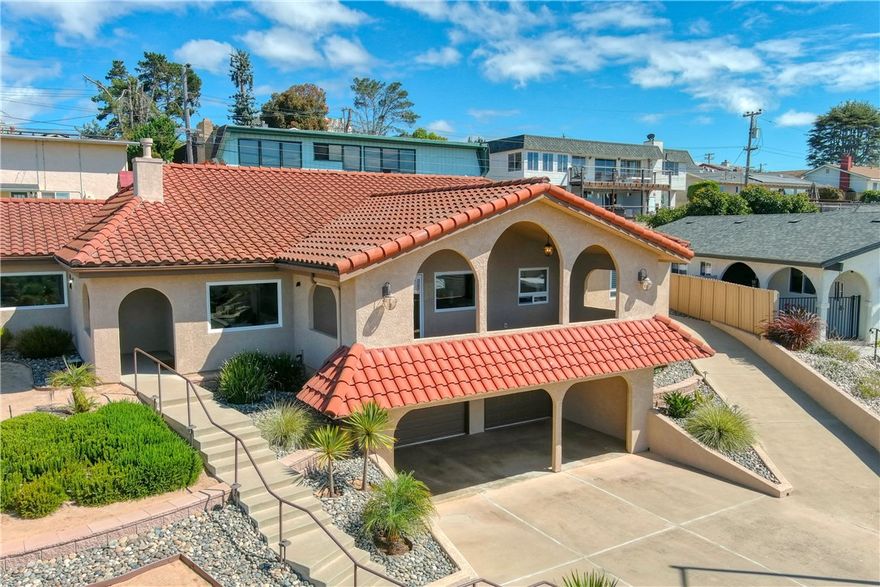 Welcome to 334 Corona del Terra, Arroyo Grande

Perched high on the hillside at the top of a quiet cul-de-sac, this elevated residence offers a vantage point rarely found in Arroyo Grande. From nearly every room and the spacious balcony, you are greeted with panoramic ocean views that stretch endlessly by day and transform into breathtaking sunsets and glittering city lights by night. The setting creates a living experience that feels both serene and inspiring, blending coastal beauty with hillside privacy.

Step inside and discover a home designed for both comfort and entertaining. The open-concept floor plan showcases soaring ceilings, premium flooring, and a soothing neutral palette that complements the natural light pouring in. The chef’s kitchen is a centerpiece with custom cabinetry, under-cabinet lighting, Frigidaire appliances, and dramatic porcelain countertops—perfect for preparing meals while still being connected to the living and dining spaces. A bonus room off the main living area makes an ideal media lounge or entertainment hub for movie nights.

The primary suite is a true retreat, offering abundant space for a sitting or reading nook, a custom walk-in closet, and a spa-like bath. With a floating dual vanity, dimmable under-cabinet lighting, a soaking tub, skylight, and elegantly designed shower, it’s the perfect place to unwind. Two additional guest en-suites provide both comfort and privacy, while a total of three full baths and two half baths accommodate gatherings with ease.

Car enthusiasts and entertainers alike will appreciate the rare four-car garage configuration: an oversized single bay plus an oversized three-car garage with fresh epoxy flooring. Just beyond is a unique “secret room” with thick walls, once used for music practice, offering a creative space for hobbies, workouts, or a private retreat.

This home is equally suited to lively entertaining or quiet evenings at home. The balcony becomes a natural gathering space, where guests can enjoy coastal breezes, golden sunsets, and the magical glow of the city lights below. At night, the professionally designed landscape comes alive with automatic garden lighting, extending the ambiance outdoors.

Blending thoughtful design, modern amenities, and a lifestyle defined by unmatched views, this home is more than a residence—it’s an experience you’ll want to call your own.