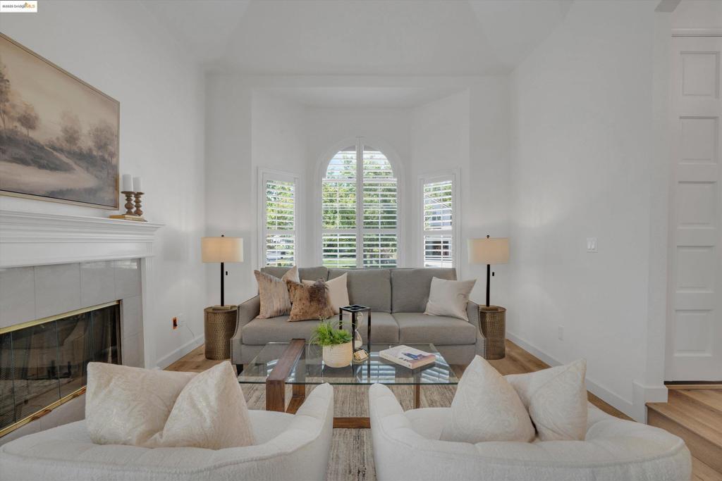 Located on a desirable corner lot behind the gates of Apple Hill Estates, this beautiful 4-bedroom, 3-bath home blends space, comfort, and style. Highlights include engineered wood flooring, plantation shutters, vaulted ceilings, nightlight feature lighting, a first-floor air filtration system, water softener, solar, and whole-house fan.  The main level features formal living and dining rooms, a spacious family room with a cozy fireplace, and sliding doors leading to a covered deck and private backyard. The rear-facing kitchen offers granite counters and backsplash, breakfast bar, nook, pantry, and abundant cabinetry. A downstairs bedroom and full bath are perfect for guests or multi-gen living.  Upstairs you'll find more bedrooms, a guest bath, and a large primary suite with vaulted ceilings, walk-in closet, dual vanities, sunken tub, and stall shower. A generous laundry room adds convenience with upper/lower cabinets, sink, and folding space.  Enjoy a private backyard with mature landscaping and patio. Apple Hill Estates offers a pool, spa, clubhouse, tennis/pickleball and basketball courts, year-round events, and 24-hour guarded gate. Welcome home.