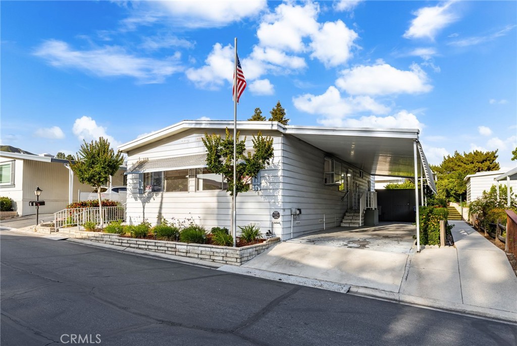 Welcome to this charming 2 bed, 2 bath home in the highly desirable 55+ community of Valencia Lea. Inside, you'll find a walk-in tub, central air and heat, and a spacious bonus room. The home also has a NEW ROOF that was replaced last year, new carpet, and multiple sheds for storage, and a large carport. Valencia Lea offers resort-style amenities including a pool, two spas, and a clubhouse—all just 5 minutes from the new Costco, restaurants, and more. Comfort, convenience, and community await!