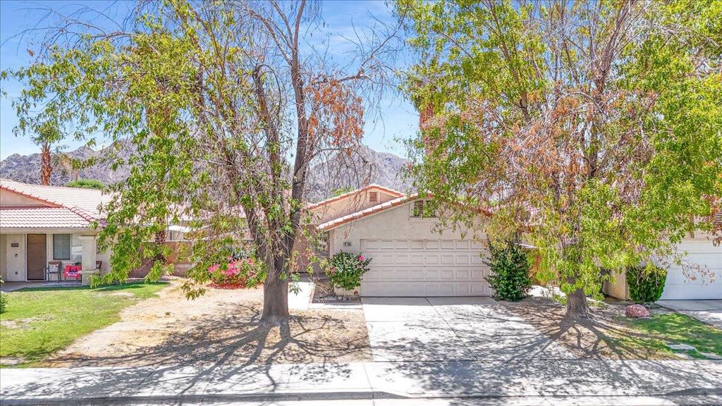 Located in La Quinta in a quiet neighborhood and close to Old Town LQ for restaurants, shopping, stores and schools. La Quinta Cove offers a large greenbelt surrounding the development and park-like setting, perfect for pets and kids. Utilities are underground and no HOA dues. 3 bedrooms, two full baths with open living room, high ceilings, fireplace, attached 2-car garage and wrap around yard that offers light and privacy. This neighborhood is a mix of second homes, investment properties and full-time residents. Successful long-term rental and now ready for a new owner to bring their vision and creativity to the property. Inside laundry room and a great canvas to create something special in a desirable neighborhood.