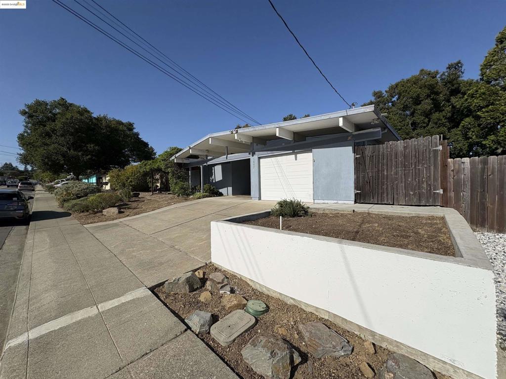 WOW! Unbelievable price for a Castro Valley Eichler. This home is priced to sell quickly! Bring your vision, your designer, your contractor, and make this excellent Eichler Home everything you've dreamed of. There are so many possibilities with this one. Large front yard with California native plants and succulents. Gorgeous pavers in the backyard create a fantastic outdoor entertainment area and still offer plenty of space for plants and a garden in the side yard. The upper area is fenced to keep pets in, but the lot extends down the hill, giving you a total lot of nearly 14,000 square feet. Inside the home, you'll find an atrium with plenty of space for plants and seating. It is currently covered, but those who prefer the open-air atrium could always remove the skylights. This home offers 4 bedrooms and 2 bathrooms, a formal living and dining room area, plus a kitchen with access to the side yard and a family room off the kitchen. (Interior photos coming soon.) The sky is the limit with this property, and at this unbelievable price, you'll be able to make the changes and upgrades you'd like. **Offer Date is scheduled for August 20th** Don't miss out. Come take a look before it's gone.