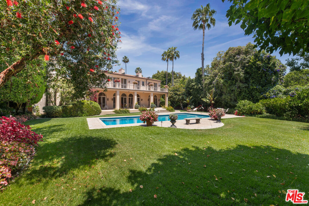 An incredible estate available at an irreplaceable value. Located in the most prime section of Beverly Hills and surrounded by major estates. A stunning Mediterranean villa designed for large scale entertaining. Enter into a grand 2 story entry foyer with sweeping staircase, high ceilings, perfect open floorplan, great walls for art and flooded with natural light. Step into a spectacular living room with stone fireplace, media room with bar, formal dining, gourmet kitchen with open breakfast room, library, and a guest wing with 2 en-suite bedrooms...all with French doors and windows overlooking breathtaking grounds. Upstairs leads to THE most luxurious primary suite in town which spans the entire top floor, measuring over 3,400 sf and features a large bedroom with sitting room and fireplace, two separate bathroom suites with two enormous walk-in size closets, 2 full offices, a gym and studio. City and tree top views, gorgeous grounds (approx. 9/10 of an acre), huge pool, expansive lawns, and gardens. Oversized 3 car garage and staff/guest parking. State-of-the-art security and cameras cover every angle of the property. Shown to prequalified clients only.