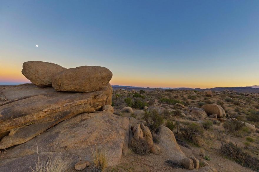 Exceptional five-acre parcel in the most sought-after section of Pipes Canyon, where properties rarely change hands. Set at the end of a quiet road, this elevated site commands sweeping 360 views of San Gorgonio, San Jacinto, and the boulder-strewn expanse and dramatic mesas of Pipes Canyon. Surrounded by vast stretches of protected land, it offers unmatched privacy, striking topography, and sculptural boulders that define the High Desert's raw beauty. Secluded enough to feel worlds away yet close to acclaimed local landmarks including La Copine, Pappy + Harriet's, the Integratron, Joshua Tree National Park, Sand to Snow National Monument, and Pioneertown Preserve. A rare opportunity for those who understand that in the High Desert, location is everything, and this micro pocket of Pipes Canyon is among the most coveted. With notable new architectural projects quietly taking shape nearby, this parcel lies at the heart of what's fast becoming one of the desert's most compelling creative enclaves.