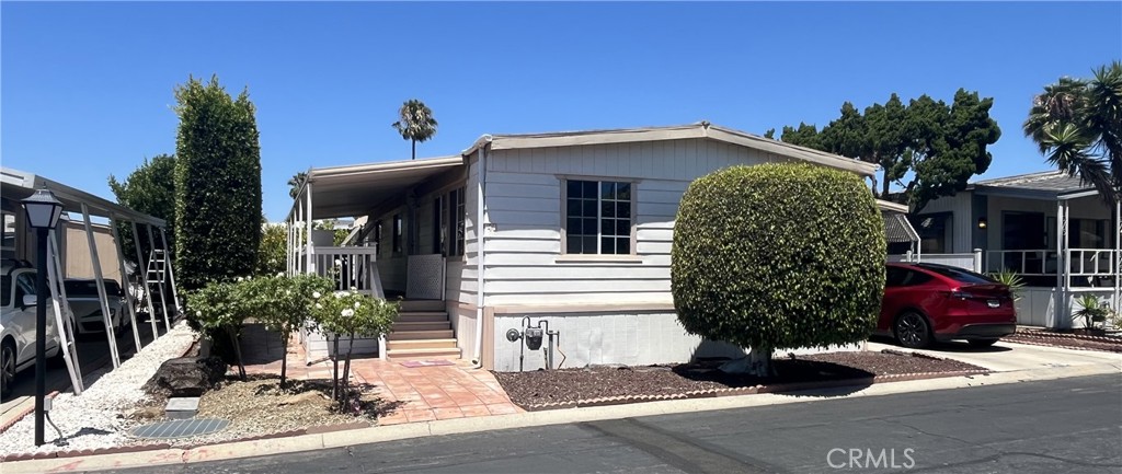 Welcome to Colony Cove – A 55+ Senior Community in Carson!
Discover this beautifully remodeled, turnkey 2-bedroom, 2-bathroom home offering approximately 1,392 sq. ft. of comfortable living space. Located in the desirable Colony Cove community, this home is move-in ready and waiting for you! Step onto the charming front porch and enter into a bright and inviting living room filled with natural light from large front windows dressed with elegant 2” faux wood blinds. The open-concept layout flows seamlessly into the kitchen and dining area, creating a warm and functional space for everyday living or entertaining. The spacious kitchen features:
• Granite countertops
• Ample overhead cabinets and counter drawers
• Included appliances: oven/range, dishwasher, refrigerator, and built-in microwave. Adjacent to the kitchen is a flexible bonus area—perfect for a dining nook, office, or cozy sitting space. The guest bedroom is conveniently located near the guest bathroom, which boasts a stunning tile walk-in shower. The primary suite is generously sized and offers enough space for a retreat corner or exercise setup. The attached primary bathroom is equally impressive, with a walk-in tile shower and ample room to move about. Additional highlights include:
• Dedicated laundry area off the kitchen
• Updated flooring throughout
• Central A/C and heating
• Backyard with lemon trees, two storage sheds, and a large covered carport. This home has everything you need to settle in with comfort and style. Start packing your bags—your new home in Colony Cove is ready for you!