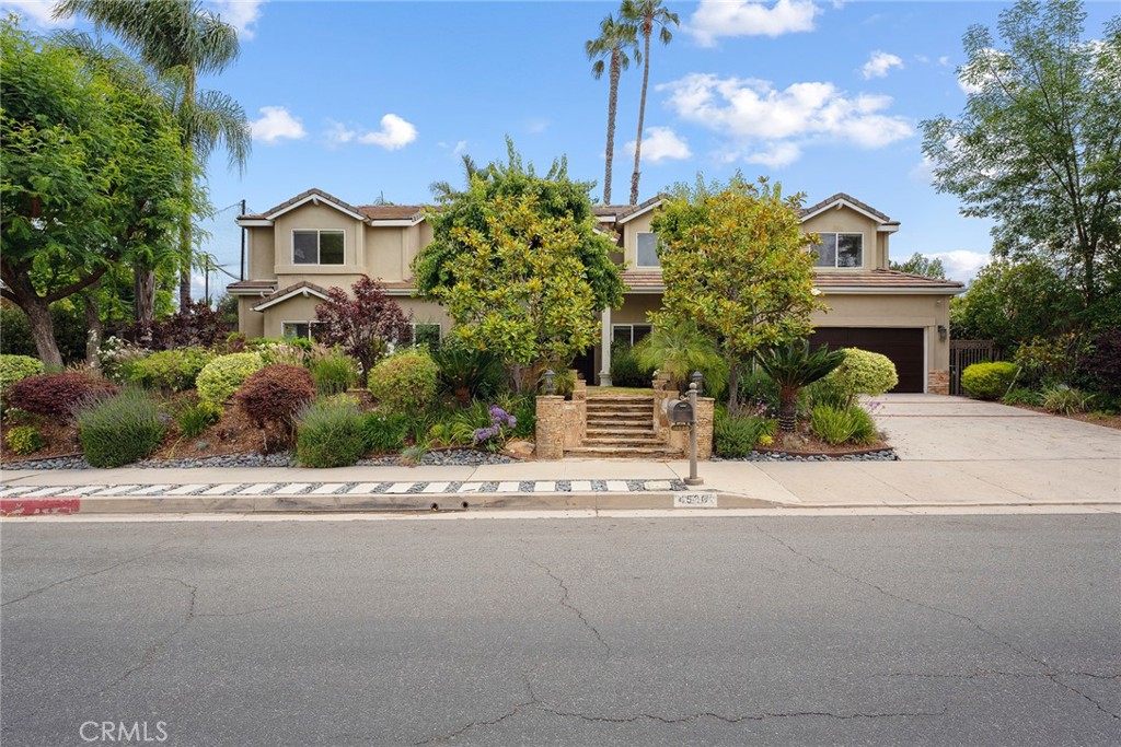 Stunning Tarzana Family Estate South of the Boulevard. Welcome to this gorgeous, over 4,600 sq. ft. family home located in one of Tarzana’s most sought-after neighborhoods, south of the Boulevard. Boasting six spacious bedrooms plus a dedicated home office, this beautifully updated residence offers the perfect blend of luxury, comfort, and versatility. The heart of the home is a remodeled gourmet eat-in kitchen, complete with high-end Wolf appliances, a large center island, and seamless flow into the elegant dining and living areas. Accented by striking wood beam ceilings and a dual-sided fireplace, the living space exudes warmth and charm, ideal for both family gatherings and entertaining. Enjoy movie nights or casual get-togethers in the expansive family room featuring a wet bar and surround sound system. Rich hardwood floors run throughout the home, adding timeless elegance. Downstairs, you’ll find a secondary primary suite with a spa-like bathroom, ideal for guests or multi-generational living. A sixth bedroom offers flexibility for a gym or additional ADU potential, and the private home office provides a quiet workspace with endless possibilities. Upstairs, the thoughtfully designed kids’ wing includes three generous bedrooms, while the luxurious primary suite offers dual walk-in closets, a spa-style bathroom, and a private balcony overlooking the lush backyard. Step outside to your own resort-style oasis
featuring a sparkling pool and spa with tranquil water features, a large grassy area, covered patio, built-in BBQ, pergola, and a sports court—perfect for making memories year-round. This exceptional property combines function and style in an unbeatable Tarzana location. Don’t miss the opportunity to make it yours!
