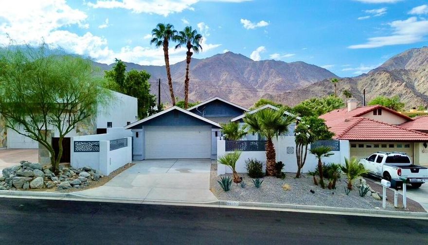 Discover this beautifully appointed and recently renovated 3-bedroom, 2-bathroom home, ideally located next to the Santa Rosa Mountains and miles of hiking trails. Renovated in 2022, this home features new doors, windows, flooring, appliances, Enjoy an open-concept living space highlighted by vaulted ceilings and ample natural light. The custom propane fireplace, equipped with a remote control, provides both fire and heat on demand for cozy winter evenings. The design features hotel-inspired colors and aesthetics throughout. Experience the spacious two-sink chef's kitchen, complete with a large center island, a Kitchaid propane gas cooktop, a bar fridge, a trash compactor, and a custom oven-microwave combo. The kitchen boasts bi-color cabinets with soft-close doors, a wine rack, and abundant storage. The master suite features vaulted ceilings, a luxurious four-poster bed set, a hotel-style bathroom design, and a walk-in closet with custom lighting and a 60-inch TV. Indulge in the master bath featuring hotel-style cabinetry, quartz countertops, a walk-in shower, and custom lighting. The guest bedroom also boasts a vaulted ceiling and a mirror closet, complete with a 60-inch TV. The guest bath offers a quartz countertop, a new Jacuzzi-style tub, elegant tile walls, and beautiful custom tile and lighting features. The outdoor pool features a large, Jacuzzi-style pool, complete with a propane heater, advanced pool controls, a waterfall, and a propane fire pit. The jade teppanyaki grill, accompanied by a bar fridge, custom lighting, misting system, and a custom-built water fountain, creates a tranquil and private space. The entire area is fenced with custom privacy panels and gates, ensuring safety for deliveries and added privacy. The oversized backyard includes extra pavers, gas plumbing for a future pizza oven or BBQ island, and low-water usage landscaping, allowing you to create your own outdoor oasis.Call today to schedule an appointment to view your future home!
