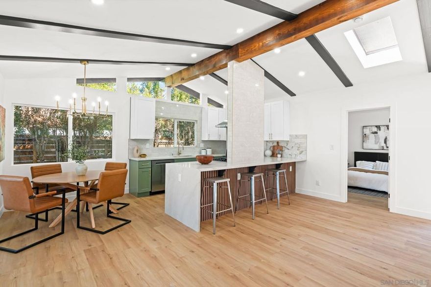 Modern comfort meets designer style in this beautifully updated 4 bed, 2 bath home featuring an open floor plan, a custom kitchen with quartz countertops, premium cabinetry, and high-end finishes throughout. Bright and spacious, the home offers premium flooring, updated bathrooms, and a private primary suite designed for relaxation. Enjoy sweeping views from large windows that fill the space with natural light, and step outside to a low-maintenance yard perfect for easy living and entertaining. The 2-car garage provides ample storage and convenience. Nestled in a peaceful Allied Gardens neighborhood, this home is just minutes from Mission Trails, community parks, admiral baker golf course, top-rated schools, and convenient freeway access.