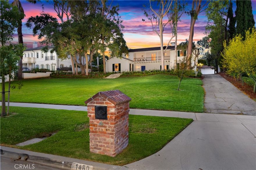 Commanding attention on one of San Marino’s most prestigious streets, 1480 Old Mill Road is an exceptional estate that embodies elegance, comfort, and architectural integrity. The two-story residence is framed by a sprawling front lawn shaded by mature trees, creating a graceful approach to a home that offers both presence and privacy. Inside, the interiors are marked by expansive proportions, real hardwood floors, and thoughtful transitions between formal and informal spaces. The living room features a classic fireplace and opens into a luminous sunroom, perfect for quiet mornings or afternoon conversation. Additional sunrooms extend from the primary suite and the secondary bedroom wing, where one of the bedrooms also enjoys a charming front-facing balcony. The updated kitchen has been designed with both beauty and function in mind. A generous center island with breakfast bar anchors the space, complemented by a designer tile backsplash, oversized refrigerator, and a sunlit breakfast nook. The adjacent dining room is substantial enough to host gatherings of any scale with ease and elegance. The family room, with its corner fireplace and ceiling fan, offers a relaxed yet refined retreat. The layout includes two full laundry rooms, one on each level, and a beautifully appointed powder room featuring a floating black vanity and rich green tile with a curated, magazine-worthy aesthetic. All bathrooms have been remodeled with timeless materials and every bedroom offers exceptional space, natural light, and comfort. The rear grounds create a true private resort experience. A covered patio sits beside the pool and leads to an outdoor dining terrace ideal for entertaining. A separate gazebo offers a peaceful escape beneath the trees. The full-size tennis court is illuminated for evening play and also includes a basketball setup, making this an ideal space for recreation and leisure. Completing the property is a detached guest house that includes a full kitchen and private two-car garage, offering ultimate flexibility for guests, extended family, or studio use. Rarely does a home combine architectural character, thoughtful scale, and such a wide array of outdoor amenities in this coveted neighborhood. 1480 Old Mill Road is a residence of enduring quality, designed for a lifestyle of ease, elegance, and distinction.