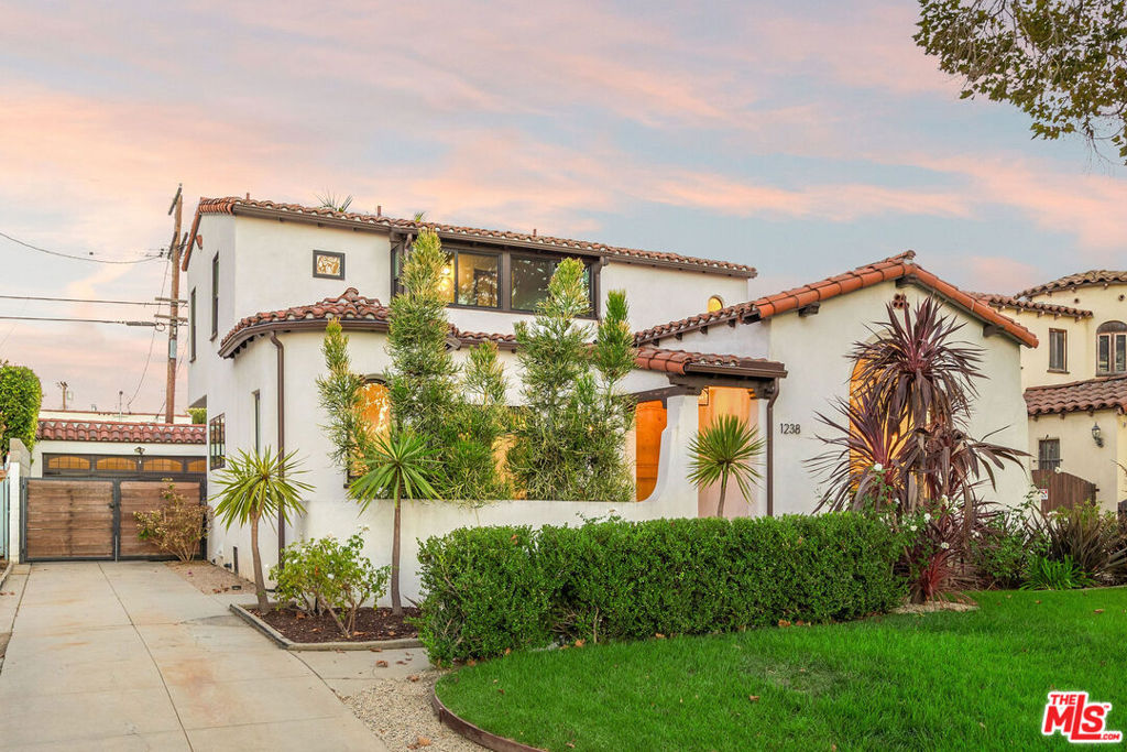 Welcome to 1238 Carmona Ave., a stunningly renovated Spanish Colonial Revival home in the highly desirable Wilshire-Vista neighborhood. This two-story residence, with three bedrooms and three and a half bathrooms, masterfully blends classic architectural charm with a soft, modern interior, offering a truly sophisticated living experience.Step through the foyer into a high-ceilinged living room that flows seamlessly into the open-concept dining and kitchen area. This space is perfect for both formal gatherings and casual meals, featuring state-of-the-art appliances and plenty of room for all your culinary endeavors. The home's second floor is a private retreat. The exquisite primary bedroom suite is a true sanctuary, complete with a spa-like primary bathroom designed for ultimate relaxation. Each of the remaining bedrooms also boasts its own en-suite bathroom, providing comfort and privacy for family and guests. Outside, a sizable rear yard awaits, offering the perfect canvas for your gardening aspirations or for hosting unforgettable gatherings. The two-car garage presents a fantastic opportunity for a potential Accessory Dwelling Unit (ADU), adding even more value to the property. The location is truly second to none. It's a convenient distance from places of worship and highly desirable schools. You can immerse yourself in the vibrant culture of the neighborhood, as The Grove, LACMA, Museum Row, and an array of shopping and dining options are all nearby. 1238 Carmona is minutes from Beverly Hills, West Hollywood, DTLA, Culver City and Century City.