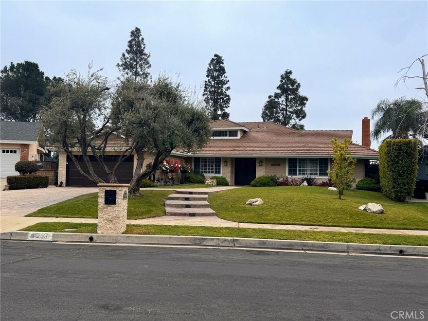 Stunning Smart Home in Porter Ranch



Nestled in a serene Porter Ranch cul-de-sac, this 4,005 sq. ft. smart home on a 13,794 sq. ft. lot offers breathtaking city lights views. Built in 1968 and meticulously updated, it features solar panels, potential for a JR ADU, and a versatile upstairs loft with a second primary suite.



Enter through elegant iron and frosted glass double doors, greeted by lush landscaping and a stamped concrete path. The tiled entry flows into an open-concept layout with bamboo floors, crown molding, and plantation shutters. The formal living room boasts a stone fireplace, built-in cabinetry, and abundant natural light.



The gourmet kitchen shines with ceiling-height cabinetry, granite countertops, custom tile backsplash, and stainless-steel appliances, including an electric cooktop, double convection oven, and dishwasher. Enjoy meals at the breakfast bar or in the bright nook with designer fixtures, opening to the backyard. The formal dining room, with built-in breakfront and designer lighting, is perfect for hosting.



The family room, ideal for a JR ADU, features a wet bar, window seating, and plantation shutters. The primary suite offers a stone fireplace, walk-in closet, arched window seating, and a sliding door to the yard. Its spa-like en suite includes dual vessel sinks, a jetted tub, multi-head shower, and stone tile floors. Two downstairs bedrooms have mirrored closets and bamboo floors, complemented by a stylish guest bath and powder room.



Upstairs, the loft with engineered hardwood, designer lighting, and a wet bar is an entertainment haven, adjacent to a second primary suite with a frameless tiled shower. Modern amenities include tankless water heaters, dual HVAC, copper plumbing, LED lights, and dual-pane windows.



The backyard oasis features a heated pebble-bottom pool and spa, outdoor kitchen, covered patio, pergola, and lush landscaping, all framed by stunning views. With parking for 6 cars and top-rated schools like Chatsworth Charter High, Nobel Middle, and Sierra Canyon nearby, this sustainable, luxurious home is move-in ready.