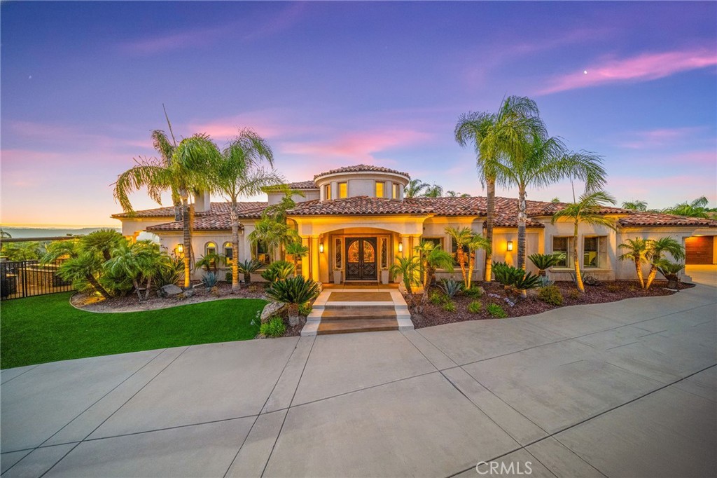 Discover unparalleled luxury and serene country living in this magnificent 4,498 sqft custom-built home, nestled on a secluded 4-acre lot. This architectural masterpiece boasts a GRAND electric gated entry and breathtaking views of the near by De Luz Hills, offering a perfect blend of elegance and functionality.
Key Features:
• Spacious & Modern Design: Soaring 10 ft ceilings throughout, with a grand 14 ft ceiling in the living room. French doors with Clearview screens ensure pest-free ventilation.
• Gourmet Kitchen: Equipped with two Bosch dishwashers, Thermador double oven, microwave, and 6-burner stove for the ultimate culinary experience.
• Luxurious Master Suite: Features two walk-in closets and a spa-like bath with three wide panoramic windows for natural light and stunning views.
• Flexible Floor Plan: Includes two additional main-floor bedrooms connected by a Jack & Jill bathroom, a spacious office with a full bath, and a convenient guest half-bath.
• Entertainment & Comfort: Surround sound system in the master suite, dining room, hallway, and grand room. Lutron Light System controls all exterior and select interior lights via smartphone app.
• Outdoor Oasis: Enjoy a fairly new saltwater Pebble Tech pool with pool lights, an outdoor barbecue and island, and a spacious upstairs balcony showcasing spectacular forest views.
• Oversized 7-Car Garage: Complete with custom cabinets and a utility sink for ample storage and convenience.
• Whole-Home Upgrades: Electrolux central vacuum, whole-house water softener, conditioner, and filtration system, plus a 75-gallon Bradford-White gas water heater. Entire home re-piped with PEX two years ago.
• Pest Protection: Taexx in-wall injectable pest defense system.
• Agricultural Advantage: 360 Haas avocado trees with an agricultural water discount.
This exceptional estate combines modern luxury with the tranquility of country living, all while offering premium features for comfort and convenience. Don’t miss the opportunity to own this one-of-a-kind Temecula retreat! Super close to Old Town Temecula and all of your favorite wineries & restaurants.
