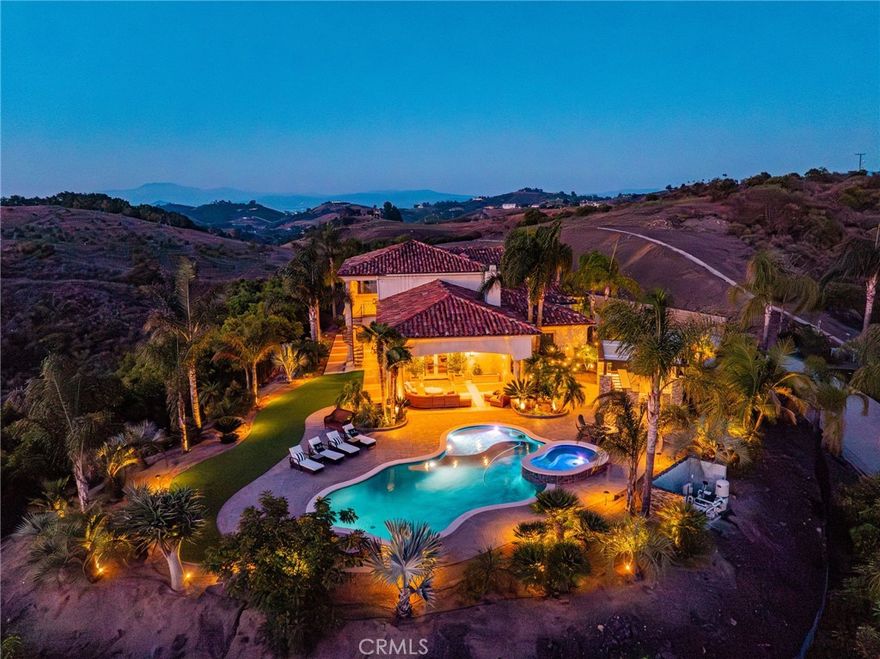 Discover unparalleled luxury and serene country living in this magnificent 4,498 sqft custom-built home, nestled on a secluded 4-acre lot. This architectural masterpiece boasts a GRAND electric gated entry and breathtaking views of the near by De Luz Hills, offering a perfect blend of elegance and functionality.

Key Features:

•  Spacious & Modern Design: Soaring 10 ft ceilings throughout, with a grand 14 ft ceiling in the living room. French doors with Clearview screens ensure pest-free ventilation.

•  Gourmet Kitchen: Equipped with two Bosch dishwashers, Thermador double oven, microwave, and 6-burner stove for the ultimate culinary experience.

•  Luxurious Master Suite: Features two walk-in closets and a spa-like bath with three wide panoramic windows for natural light and stunning views.

•  Flexible Floor Plan: Includes two additional main-floor bedrooms connected by a Jack & Jill bathroom, a spacious office with a full bath, and a convenient guest half-bath.

•  Entertainment & Comfort: Surround sound system in the master suite, dining room, hallway, and grand room. Lutron Light System controls all exterior and select interior lights via smartphone app.

•  Outdoor Oasis: Enjoy a fairly new saltwater Pebble Tech pool with pool lights, an outdoor barbecue and island, and a spacious upstairs balcony showcasing spectacular forest views.

•  Oversized 7-Car Garage: Complete with custom cabinets and a utility sink for ample storage and convenience.

•  Whole-Home Upgrades: Electrolux central vacuum, whole-house water softener, conditioner, and filtration system, plus a 75-gallon Bradford-White gas water heater. Entire home re-piped with PEX two years ago.

•  Pest Protection: Taexx in-wall injectable pest defense system.

•  Agricultural Advantage: 360 Haas avocado trees with an agricultural water discount.

This exceptional estate combines modern luxury with the tranquility of country living, all while offering premium features for comfort and convenience. Don’t miss the opportunity to own this one-of-a-kind Temecula retreat! Super close to Old Town Temecula and all of your favorite wineries & restaurants.