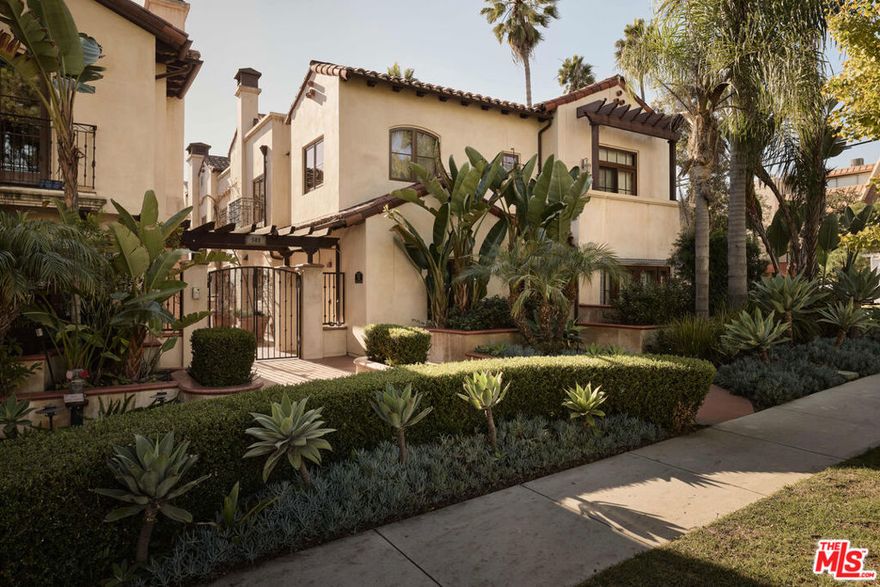 Just moments from Montana Avenue, this spacious Spanish townhouse sits on a peaceful, tree-lined stretch of 17th Street and offers generous interiors, remarkable natural light, refined craftsmanship, and thoughtfully designed privacy. Set within an impeccably maintained courtyard community, Unit 8 welcomes you with classic arches, terracotta detailing, and a lush landscape of mature palms and sculpted hedges. Inside, sunlight fills the well-proportioned living and dining areas. French doors open to a charming terrace, one of three private outdoor spaces. The cook's kitchen features stone countertops, Viking appliances, and abundant cabinetry designed with rich materials and functional hardware. Upstairs, the primary suite includes its own fireplace and a spacious bathroom finished in warm stone, complete with a soaking tub and separate glass shower. Two additional bedrooms complete the upper level. A standout feature is the serene, private rooftop terrace, an extension of the home with sweeping views, a pergola, and multiple seating areas. It's a true Santa Monica luxury: space to unwind, entertain, or simply enjoy the coastal breeze and palm-tree views. Additional amenities include in-unit laundry, central air, secure entry, and private gated garage parking. This coveted location offers close access to Santa Monica's best dining, shopping, and the beach.