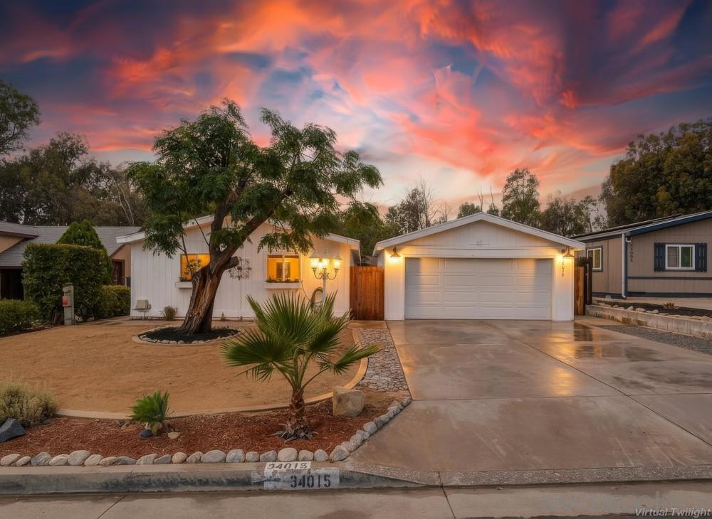 Welcome to this beautifully updated Farmhouse-style 3 bedroom, 2 bathroom home in the coveted community of The Farm. Thoughtfully designed with an open-concept layout and soaring ceilings, the home offers a light and airy feel throughout. The gourmet kitchen is a true showpiece with Carrara-style quartz countertops, stainless steel appliances, apron sink, and a large center island overlooking the living room—perfect for entertaining. The primary suite features a stunning designer bathroom with double vanity, stylish tiled shower, and elegant finishes. Additional highlights include energy-efficient Low-E windows, a separate indoor laundry room, and a two-car garage with a versatile two-room workshop. Outdoors, enjoy a spacious backyard with mature trees—ideal for relaxing, gardening, or gatherings with family and friends. Living in The Farm means access to unmatched amenities: 600 acres of common space, citrus groves, hiking trails, 3 pools, 2 spas, sports courts, a fishing pond, amphitheater, RV storage, community garden, and family-friendly parks—all for under $70/month HOA dues.
