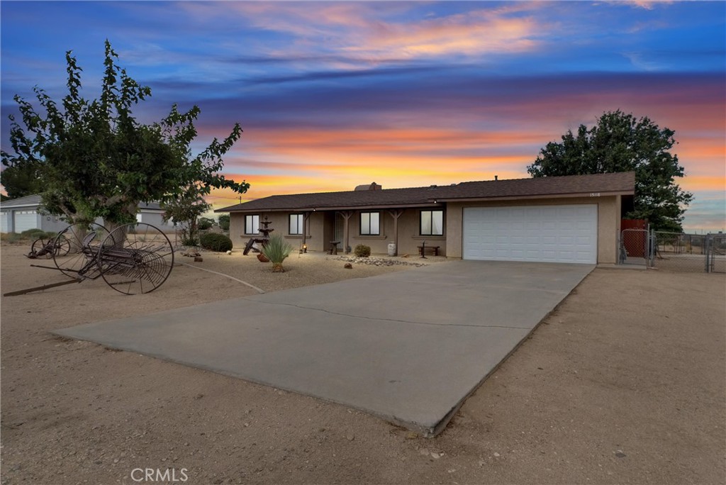 Welcome to your serene ranch retreat in Hesperia, with breathtaking mountain and hill views in every direction! Situated on a flat, sprawling 43,710 sq ft lot, this charming single-story home offers 3 bedrooms, 2 baths, and approximately 1,458 sq ft of living space. From the moment you arrive, the inviting curb appeal shines with an extra-long driveway, rustic Western touches, and a peaceful setting. Step inside to a bright, open floor plan filled with natural light. The living room is the heart of the home, anchored by a large brick fireplace. It flows seamlessly into the dining room, highlighted by a lovely chandelier, and into the spacious family kitchen with freshly painted cabinetry, a breakfast bar, and a brand-new dishwasher. The master suite features direct patio access through sliding doors and a private bath with a walk-in shower. Two additional bedrooms are generously sized and share a full hall bath with a shower-in-tub. Recent updates include fresh paint, upgraded baseboards, ceiling fans throughout, a wall AC unit in the living room, and newer sliding doors. Outdoors, you’ll find multiple patios designed for relaxation and gatherings. Just off the living room, a covered patio with a ceiling fan creates a breezy, charming space perfect for family get-togethers. The fenced backyard also offers a manicured lawn, mature trees, and a professional irrigation system. A second patio, right off the master bedroom, is beautifully shaded by grapevines. Beyond the fenced yard, the property continues with a barn, chicken coop, and utilities already connected for water and electricity, ideal for anyone looking to keep animals. With its flat, usable acreage, this property is perfect for horses, RVs, additional vehicles, or even an ADU. All this in a tranquil setting, yet just minutes to main roads, shopping, dining, and entertainment. Don’t miss this versatile home with endless potential!