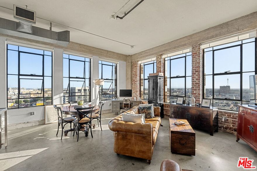 Welcome to your urban sanctuary in the heart of Downtown Los Angeles! This stylish live/work loft offers over 640 sq ft of open-concept living, blending modern design with historic character. Perched on the 10th floor, the space features soaring ceilings, polished concrete floors, and NINE massive industrial-style windows that flood the home with natural light while framing stunning city views. The sleek kitchen with minimalist cabinetry and designer lighting opens seamlessly into the spacious living and dining areas, perfect for entertaining or inspiring creativity. The bedroom nook offers privacy while maintaining the open loft feel, and the contemporary bathroom is finished with clean lines and modern fixtures. Washer and dryer located in the unit.A dedicated subterranean parking space within the complex. Santee Village amenities include the following: Rooftop sun deck, BBQ grills, gym, rooftop basketball court, driving range, rooftop pool and spa.Within walking distance to award winning restaurants, museums and the best coffee shops. A stone's throw away to the Metro Station, L.A. Live, Crypto Arena and freeways. In the center of the action, but quiet and peaceful in the loft itself  Listed on the National Register of Historic Places, the Textile Building is a former factory building, 12-story, 69-unit Gothic Revival Landmark. Listed under the Mills Act - earning homeowners generous savings on property taxes. The Mills Act automatically transfers to the new homeowner.