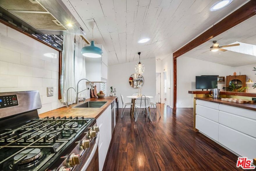 Luxurious, custom-designed single family home with over $200K upgrades (including solar!). Enjoy the warmth & modern design in this 3 bedroom 2 bath 1500 sq ft home w/bonus room. Here, natural wood covered ceilings compliment a luminous rainbow prism skylight. Features and upgrades include tiled floors, a newly renovated kitchen with state-of-the-art appliances, and a designer bathroom with a spa-like Japanese soaking tub. This exquisitely appointed home includes an enclosed sunroom with reflective glass windows and a living room where vaulted ceilings with skylights fill the open space. Other upgrades include a newer roof as well as an EV charging port to lower utility bills and charge vehicles and lower your carbon footprint. Custom built bathrooms that include a waterfall shower, glass & full-body bath with stone tiles and hand shower. Additionally there is a Halo 5 filtration system for the entire house providing 5 stage reverse osmosis filtration for drinking water; and a landscaped garden complete with Meyer lemon and Pomegranate trees and an irrigation system. This recently painted house accents new boarders with illuminated cascading steps, exterior lighting and a outside facade made of oakwood. Enter the private garden "tree-house" enclosed with 30 UV protective awning and bird sanctuary - enjoy  all fresco dining day and night. Also included: New lighting fixtures, shutters, a tandem washer dryer, a kitchen dining bar with lit cupboards & newer stainless steel appliances. The entire home is fenced in with two parking spots. Sale also includes 2 sheds and a Wecall system to boost wi-fi signal. This gated community is a hidden gem in Los Angeles - and recently underwent 12 million dollar infrastructure upgrade and the home purchase includes the assessors parcel making the community one of the very few of its kind. Along with amenities including a pool, sauna, workout room, and RV parking, there are hiking trails outside the door, security guard service, and an on-site management. Located in the stunning natural wonderland that is Topanga Canyon, featuring hiking and biking trails, outdoor theatre, top restaurants and cafes, hip boutiques, proximity to the beach, Calabasas and so much more - Come see what this unique community has to offer! FHA AND VA APPROVAL FOR LOW DOWN PAYMENT LOANS