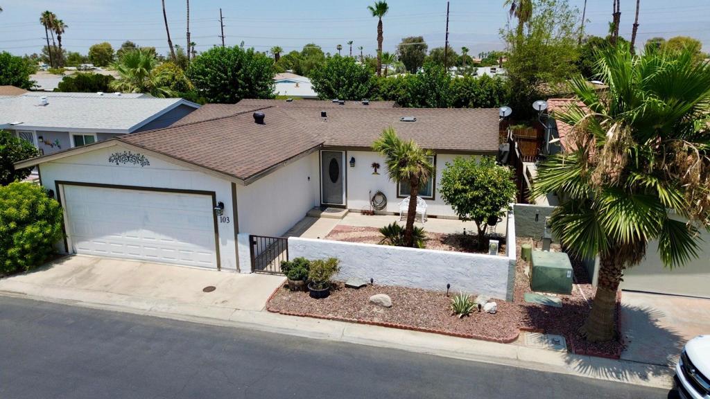 Discover your new home at 81461 Avenue 48, Unit #103, nestled in the highly sought-after Desert Grove 55+ community. This charming and meticulously maintained residence offers two spacious bedrooms and two modern bathrooms, covering an ample 1,210 sq, ft. of living space. Built in 1981, this home sits on a generous 3,920 square foot lot and boasts numerous upgrades that blend comfort and style. As you enter into the house you will feel right at home, there is a spacious living room perfect for relaxing after a long day, Natural light pours in through the sliding door, providing easy access to the covered back patio. Adjacent to the kitchen is a charming dining area, ideal for enjoying daily meals or hosting special occasions. The upgraded kitchen itself features lots of cabinets plus all appliances, water softener are included on this sale. The heart of the home features contemporary finishes and a welcoming atmosphere perfect for relaxation and entertaining. The 2-car attached garage not only provides secure parking but also features oversized area. Step outside into the backyard, where you'll discover a covered custom-built patio. Desert Groves is an active senior community renowned for its low HOA fees and abundant amenities. Enjoy leisurely days at the clubhouse, take advantage of convenient RV parking, or unwind in one of the 3 sparkling pools. This exceptional property is a rare find in a well-cared community.