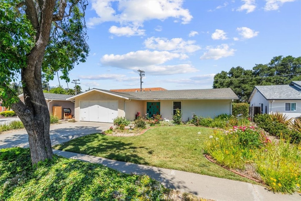 This single level 3 bedroom, 2 bath was the tract's model home in 1963. Its landscaping with roses and other flowers in the front yard and mature lemon and orange trees in the rear yard enhances the attractive exterior appeal. Step through the faux double front door into a welcoming entryway. To the left is a flex room. Its mid-century style presents a palette for a buyer's design touches and the floor plan offers an opportunity to open up the kitchen as in today's open concept designs. Floor to ceiling windows on each side of fireplace (inoperable) infuses natural light into living area. Dining area slider expands living space to the outdoor yard and patio. A full bathroom is off the hallway. Bedroom closets are good sized and the home has abundant storage throughout. The en-suite bathroom in the primary suite has a full-size step-in shower. Replacing the large primary suite window with a slider or French Door would provide direct access to the rear yard. This home offers many options for enjoyment! Information not verified.