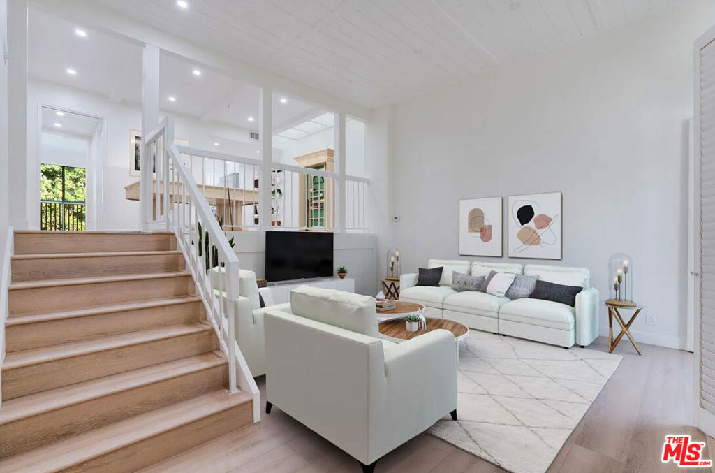 Step into style and comfort in this beautifully updated residence located in Oakcreek, one of Calabasas' most sought-after gated communities. A private gate entry leads into a fenced front patio, creating a warm and secluded welcome. Inside, contemporary design meets timeless charm featuring rich wood floors, soaring paneled ceilings, recessed lighting, and a skylight that fills the home with natural light. The spacious living room includes a cozy fireplace, sliding glass doors to the front patio, and direct access to the private 2-car garage below.Upstairs, a unique lofted flex space with exposed beam ceilings and a dramatic skylight serves perfectly as a dining area, family room, or creative workspace. The adjacent gourmet kitchen is fully equipped with stainless steel appliances, a farmhouse sink, quartz countertops, white cabinetry, and a breakfast bar that flows into the dining area and nearby powder room. Built-in hallway shelving adds both character and function, while laundry hookups are smartly tucked away for convenience.The top level features two generous bedrooms. A rear en suite bedroom offers mirrored closets and privacy, while the expansive primary suite at the front of the home includes a fireplace, a walk-in accessory closet, and a private balcony perfect for morning coffee or evening relaxation. The spa-inspired primary bath boasts dual vanities, a soaking tub under a skylight, a separate walk-in shower, and a custom walk-in closet with built-ins.Community perks include a sparkling pool and spa, plus exclusive access to serene Calabasas Lake. Directly across the street, enjoy the Calabasas Tennis & Swim Center, and just a short 5-minute stroll takes you to premier shopping and dining at The Commons. Zoned for the award-winning Las Virgenes Unified School District.
