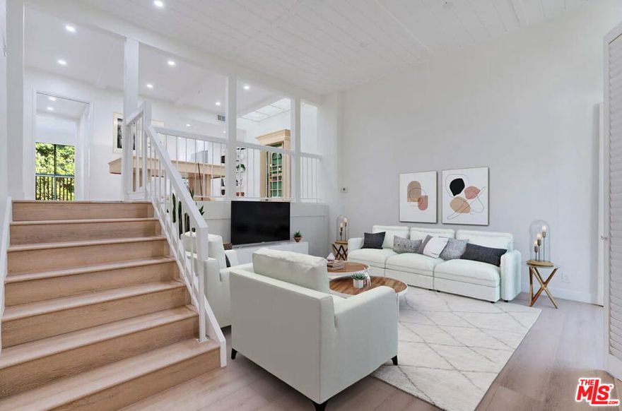 Step into style and comfort in this beautifully updated residence located in Oakcreek, one of Calabasas' most sought-after gated communities. A private gate entry leads into a fenced front patio, creating a warm and secluded welcome. Inside, contemporary design meets timeless charm featuring rich wood floors, soaring paneled ceilings, recessed lighting, and a skylight that fills the home with natural light. The spacious living room includes a cozy fireplace, sliding glass doors to the front patio, and direct access to the private 2-car garage below.Upstairs, a unique lofted flex space with exposed beam ceilings and a dramatic skylight serves perfectly as a dining area, family room, or creative workspace. The adjacent gourmet kitchen is fully equipped with stainless steel appliances, a farmhouse sink, quartz countertops, white cabinetry, and a breakfast bar that flows into the dining area and nearby powder room. Built-in hallway shelving adds both character and function, while laundry hookups are smartly tucked away for convenience.The top level features two generous bedrooms. A rear en suite bedroom offers mirrored closets and privacy, while the expansive primary suite at the front of the home includes a fireplace, a walk-in accessory closet, and a private balcony perfect for morning coffee or evening relaxation. The spa-inspired primary bath boasts dual vanities, a soaking tub under a skylight, a separate walk-in shower, and a custom walk-in closet with built-ins.Community perks include a sparkling pool and spa, plus exclusive access to serene Calabasas Lake. Directly across the street, enjoy the Calabasas Tennis & Swim Center, and just a short 5-minute stroll takes you to premier shopping and dining at The Commons. Zoned for the award-winning Las Virgenes Unified School District.