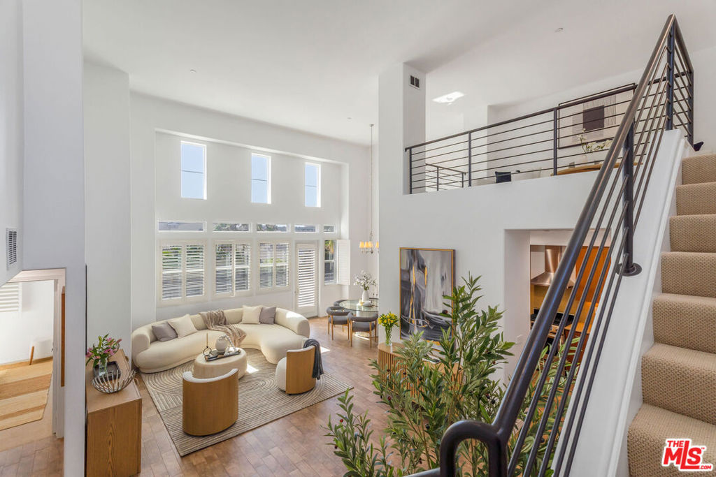 Welcome to your new slice of Playa Vista perfection! This rare top-floor residence has wow-factor written all over it. Let's start with those soaring ceilings and floor-to-ceiling windows that drench the whole place in golden California sunlight. Add in a west-facing balcony with bluff views and you've got yourself the ultimate front-row seat for jaw-dropping sunsets every night. Inside, the open-concept kitchen + dining setup makes entertaining a breeze, while the convertible loft flex space can easily transform into a private third bedroom, home office, or creative studio. Both bedrooms boast those same airy, high ceilings, giving everything a feeling of modern grandeur. But the real showstopper? The huge master retreat that takes up an entire wing of the penthouse-like home, it's as fabulous as it sounds. And the location? Truly unbeatable. You're a block from The CenterPointe Club (think pool, gym, and social hub all rolled into one), plus similar distance to trails, sports courts, the Playa Vista library, and Playa Vista Elementary (one of California's top schools).