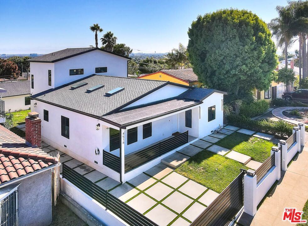 DESIGNER NEW CONSTRUCTION AND GUEST HOME ADU - This organic oasis, with its clean lines and integrated technology, makes this large family home truly one of a kind. Uncompromising quality is evident throughout, from the soaring 19-foot ceilings, skylights and mill-work. A MUST SEE! Take a deep breath and admire how the open floor plan wraps gracefully around the home's centerpiece - the designer dream kitchen. A waterfall Island features vegetable sink and plenty of space for dining and intimate gatherings. The Gourmet kitchen is equipped with top-of-the-line brand new appliances, convection oven with 6 gas burners, custom cabinetry, and state-of-the-art convection microwave. Expansive interior features four en-suite bedrooms, and a total of seven beautifully appointed bathrooms. Retreat to the lavish primary suite with stunning views, ocean peek on clear days, which has it's own steam rain shower spa-like bathroom. Both main house and ADU have Smart-Home technology specifically tunable lighting that can be customized seamlessly throughout the day. A central control dashboard monitors systems and allows you to program scenes for automated shades, climate, security and voice controlled features. Adjust morning energy or evening relaxation while supporting circadian rhythms. The "Brilliant" interface, which can patrol preset paths so you can check on any room while away. Thoughtfully designed for seamless indoor-outdoor flow, the expansive front and back yards offer complete privacy, creating a true sanctuary in the city. Designed by esteemed architect Kevin May Homes, renowned builder, this residence represents the pinnacle of craftsmanship and style. EXTRAORDINARY ADU - Design details include a robust chef's kitchen, outfitted with two custom bathrooms swathed in onyx & stone, plus a one-of-a-kind stone wall embedded to high ceilings. The rear home enjoys it's own views and private back yard. Effortlessly earn income from this 2 bedroom 2 bath property or extend to family guest. Close to everything - 7 mins to Silicone Beach, Marina Del Rey and 10 minutes to beaches. New Intuit Dome, (NBA All Star 2026) Sofi stadium. Walking distance to family friendly restaurants and state parks. Windsor Hills Adjacent. ADU VR https://my.matterport.com/show/?m=UrxtjfZeSLE&brand=0