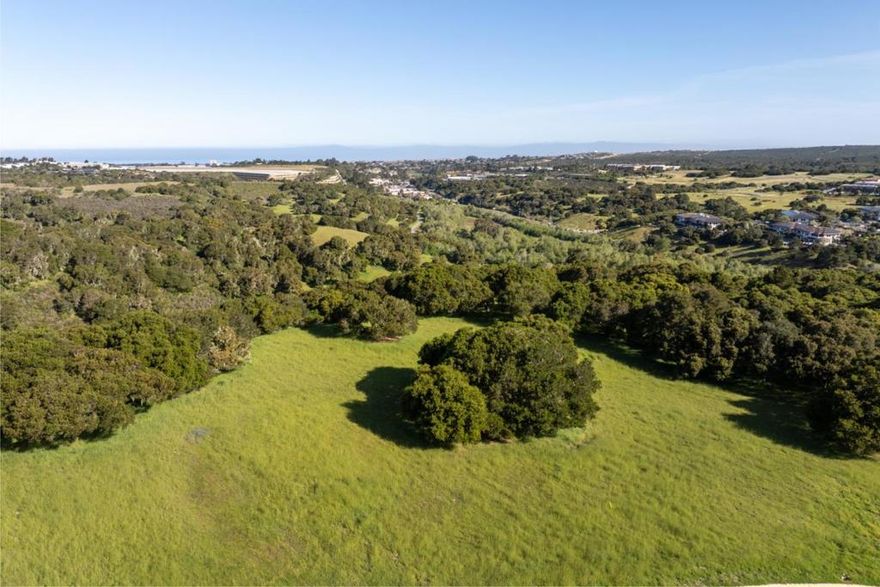 This stunning 1.990± acre parcel in Monterra is sited on a sunny hillside among mature oak trees and offers breathtaking views of Monterey Bay, the Santa Cruz Mountains, and the Steinbeck Hills. The gently sloping driveway leads to a spacious open meadow and a 0.82± acre building envelope, providing the perfect canvas for your dream home. Enjoy more favorable weather than the coast in a serene, park-like setting, surrounded by natural beauty. The property benefits from underground utilities, including water provided by the Canada Woods Water Company, a private service provider for the Monterra and Tehama communities. A social membership to the exclusive Tehama Golf Club is included with the purchase, offering access to multiple dining venues, social events throughout the year, and a full range of amenities at the sports center including two pools, tennis and pickleball courts, weight machines, organized fitness classes and personal trainers. Monterra Ranch is a private, gated community just 3 miles inland, only minutes from world-renowned golf courses, shopping, dining, wine tasting, hiking and biking trails, sandy beaches, a regional airport and the famous Laguna Seca Raceway.