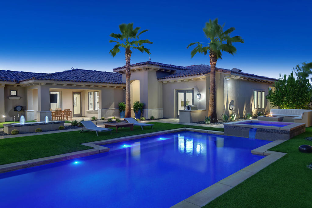 Embodying the perfect balance of sophistication, comfort, & technology, this exquisitely appointed fully furnished smart home is set within the exclusive gates of Toscana Country Club & situated on 1 of 2 signature Jack Nicklaus golf courses. Positioned on a premier 1/3rd acre lot, commands sweeping views over the 10th fairway & offers ultimate privacy & resort-style living. A private gated courtyard sets the stage for unforgettable entertainment, where dramatic southern mountain views frame a saltwater pool, spa, firepit, water feature, putting green, & BBQ cook station. The space is enveloped in lush landscaping, low maintenance high-end organic turf, dramatic lighting, & paver walkways guiding the experience. The rear outdoor space offers a covered paver patio, BBQ cook station, linear fire pit, & water features - all with elevated seclusion overlooking the fairway & panoramic vistas. With over 3,600 square feet of refined interior, the home boasts 4 ensuite bedrooms, including a private casita, & 4.5 baths. The interiors exude a timeless yet contemporary elegance with light, modern tones & high-end porcelain flooring. Soaring ceilings, Fleetwood sliding pocket doors, & walls of glass flood the family room with natural light & create seamless indoor-outdoor flow. The gourmet kitchen impresses with granite countertops, Wolf appliances, a SubZero refrigerator, & European cabinetry. Adjoining dining area with wet bar & beverage cooler invites effortless entertaining. The primary suite is a private sanctuary with a spa-inspired bath featuring dual vanities, granite countertops, & a custom walk-in closet. Rare cutting-edge amenities such as Control4 automation, illuminated light switches & lighting sensors, automated designer drapery, keyless entry, & high-end TOTO Neorest toilets are seamlessly integrated throughout. Additional innovations include keyless entry, a digital home security system with interior and exterior cameras, high-performance windows, a smart water valve, high-efficiency AC & heating, and energy-saving LED lighting. Thoughtfully redesigned, the mudroom, hobby area, & laundry room provide seamless organization. Newly epoxied 2 car garage & golf cart garage add polished practicality. Offered fully furnished, this home is ready to enjoy from day one. Just moments from shopping, fine dining, & much more, this home offers the rare opportunity to live a life of elegance, innovation, & leisure in one of Indian Wells' most sought-after enclaves.