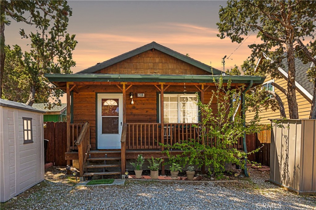 Welcome to Your Dream Mountain Cabin! Built in 2005, this cozy 2-bedroom, 1-bath mountain cabin is move-in ready and full of charm. Tucked away in a peaceful pocket of Big Bear, it’s a place where you can slow down, breathe deep, and truly enjoy each day. Warm wood finishes, vaulted ceilings, and natural light fill the home with a welcoming and relaxing vibe. Whether you're relaxing or gathering with friends in the open-concept living area by the wood-burning stove, enjoying a quiet morning coffee, this is a perfect space to relax and recharge. The fully equipped kitchen offers generous counter space and an eat-in dining nook, ideal for everything from quick breakfasts to cozy dinners. Daily chores are eased with handy washer and dryer. Step outside to the spacious, south-facing deck that overlooks beautiful mountain views. It’s the perfect spot to BBQ, do yoga, take an afternoon nap, write, paint, or simply enjoy the sun. At night, stargaze under Big Bear’s clear sky. The fully fenced yard is great for kids or pets, and the gravel driveway can fit 2 to 3 cars with ease. Trails for walking, hiking, or running are just steps away, adding to the peaceful, nature-filled lifestyle this home offers. Whether you're looking for a full-time residence, weekend retreat, vacation rental, or a creative escape, this cabin has it all. Just minutes from ski slopes, the lake, The Village, and more, this is Big Bear living at its best. An exceptional value you don’t want to miss. Make it yours today!