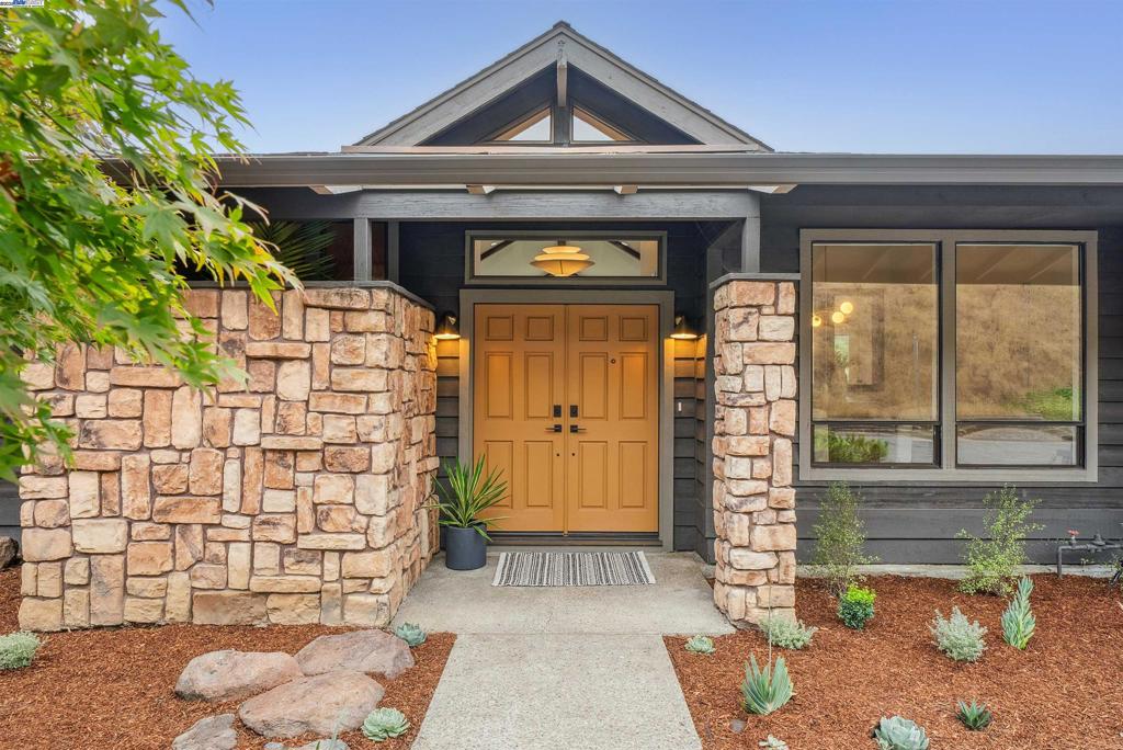 Perched on a private road above a canopy of trees, this architectural sanctuary offers sweeping, unobstructed views of Chabot Park. Soaring ceilings and a dramatic cathedral window flood the home with morning light while a large balcony frames million-dollar park vistas. Each room oriented to embrace the view blurs the line between indoors and out. New luxury flooring grounds the open layout, while an updated kitchen stuns with updates and a view. On cool evenings, the fireplace becomes the heart of the home—adding warmth, ambiance, and a backdrop for cozy moments. The spacious primary suite is pure serenity, with two separate closets, as well as a luxe ensuite bath with double sinks, a soaking tub and separate shower. Two lower bedrooms offer space and privacy, plus a large bath with potential for expansion. A laundry room with generous storage, 3-car garage, attic, and closets aplenty bring beauty and function. An artists’ rendering to create additional backyard access offers further connection to the outdoors. An enormous terraced backyard, dotted with fruit trees offers endless potential for making the space your own. Just a block from Bay-O-Vista Swim & Tennis Club, minutes to Lake Chabot, and easy access to 580 - discover a rare intersection of luxury, privacy & nature.
