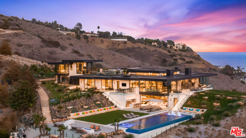 Just Reduced. Newly-constructed, one-of-a-kind modern masterpiece overlooking Carbon Beach with unobstructed, jaw-dropping ocean views. Situated on 22+ acres, this plush Property located in the prestigious Carbon Beach Terrace Estates is dual-gated and features a dramatic glass entry with an enormous pivot door, and soaring ceilings and ultra-chic furnishings and fixtures throughout. Meticulously curated with dazzling details throughout, this diamond beach pad nestled on a prominent plot overlooks the city of Malibu and offers unobstructed views of the iconic Malibu Pier. Rich with elegant furnishings and exquisite design details, this custom coastal build is comfortable, luxurious and constructed with the highest quality materials and craftsmanship with stylish distinction and sophistication. Beautifully framed with light-filled living spaces and bespoke architectural details including a glistening glass staircase (that truly makes a statement) that serves as the focal point of this one-of-a-kind Property. Well appointed master suite, luxury living quarters, gourmet chef's kitchen, elevator, mudroom, fitness center, indoor spa, steam room/sauna, hair salon, private massage area, infinity pool w/jacuzzi, private sandy beach and ample outdoor area complete w/BBQ is made for entertaining. Other amenities include well-appointed guest quarters w/stunning, resort-style rooftop deck, state-of-the-art cinema, private poker room, multiple terraces w/fire pits perfect for indoor/outdoor living. Prime location close to Nobu and Soho House.