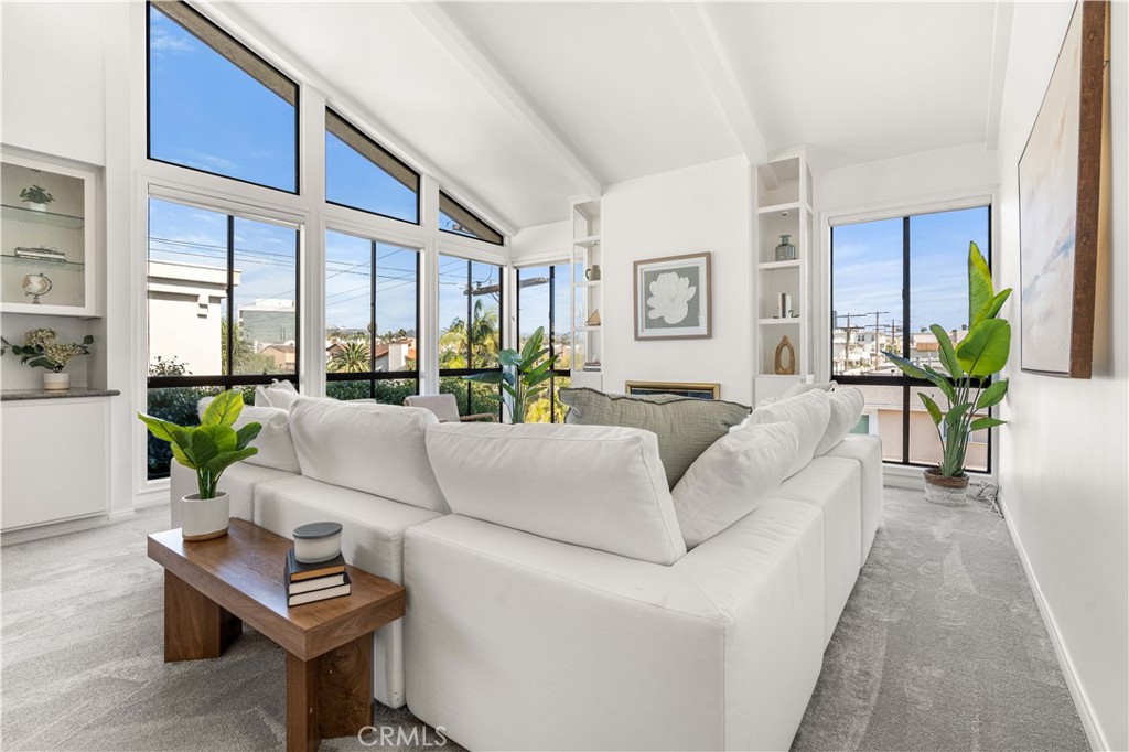 Penthouse living with a view of the Getty in the heart of prestigious Brentwood! This sophisticated top floor corner unit combines a spacious open floor plan with soaring vaulted ceilings. Flooded with natural light, this home features 2 generously-sized bedrooms and 2 bathrooms. The functional kitchen features granite countertops, plentiful cabinetry and storage, stainless steel appliances, and a quaint breakfast nook for sipping your morning coffee. The sheer amount of space devoted to the dining and living areas is jaw-dropping. A gas fireplace and tons of windows overlooking the treetops of the neighborhood and the Getty in the hills make it feel cozy and airy all at the same time. Two sliding glass doors open up to a private balcony with beautiful planters of succulents and low-water plants. The primary suite offers a true retreat tucked into the back of the unit with a bathroom featuring a separate shower and bathtub, two separate toilets, loads of dual vanity space, and two walk-in closets. The second bedroom is perfect for a guest bedroom, office, or nursery and benefits from the full guest bath across the hall. Tired of community laundry? No worries - here you'll have your own private laundry room with washer and dryer included, and plenty of storage and closet space. New carpet, fresh paint throughout, modern light fixtures, window treatments, AC, and a brand new heater ensure you'll be ready to move in and get comfortable. Two side by side parking spots near the building elevator in the gated garage, a lockable storage cabinet, and a pool and spa make for convenient living, just moments away from all of the Brentwood shops, restaurants, and schools. The reasonable HOA fee includes master insurance, earthquake insurance, water, trash, sewer, landscaping and the amenities. Close to the beach, 405, UCLA and so much more - come see this special home and make it yours!