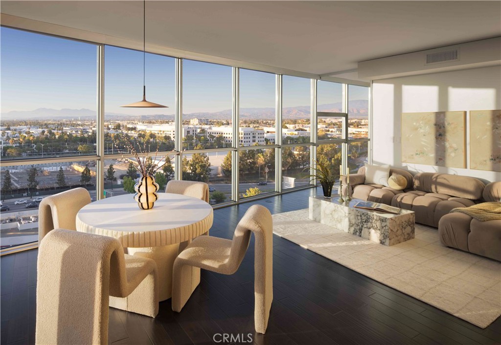 Welcome to Skyline OC — the tallest residential building in Orange County and South Coast's boldest condo transformation, where timeless design meets coastal energy. Ideally located in the heart of Orange County, Skyline OC offers the perfect balance of urban convenience and resort-style tranquility. Just moments from South Coast Plaza, world-class dining, performing arts, and major business hubs, this exceptional address puts everything within easy reach—while still feeling like a private retreat.
Residence N1108 is a corner home with a wraparound terrace and northwest-facing views of the city skyline and dreamy sunsets. At ~1,445 square feet, this A Plan residence offers an open split floor plan with bedrooms on opposite sides, plus a versatile den for work or leisure. Floor-to-ceiling windows flood the space with natural light along with dark wood flooring. Designer wall coverings throughout accentuate this model residence with upgraded closets.