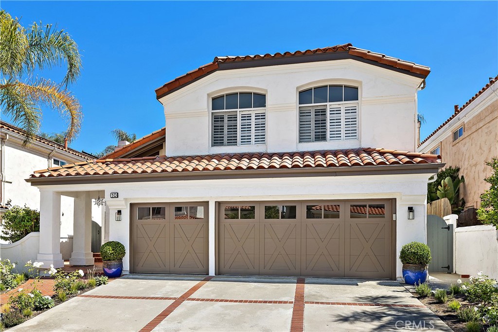 Discover the essence of coastal elegance at 10 Novilla, tucked away on a peaceful cul-de-sac in the prestigious Marina Hills neighborhood of Laguna Niguel. This beautifully reimagined four-bedroom, two-and-a-half-bath home blends timeless Mediterranean architecture with fresh, modern updates. Sunlight fills the airy interior, where new carpet and designer paint enhance the open layout. The living and dining rooms transition seamlessly into a warm family space centered around a fireplace. The kitchen invites both casual meals and entertaining, offering backyard, surrounding hills and ocean-skyline views. Upstairs, the primary retreat features dual walk-in closets, a sparkling chandelier, and a spa-style bath with soaking tub. Three additional bedrooms complete the upper level. Outdoors, redesigned gardens, lush lawn space, and raised planters create a serene setting. Recent upgrades include new HVAC, water heater, garage door, and exterior paint. Marina Hills residents enjoy resort-like amenities: pool, spa, clubhouse, tennis, pickleball, and more—all minutes from Dana Point Harbor and renowned beaches.