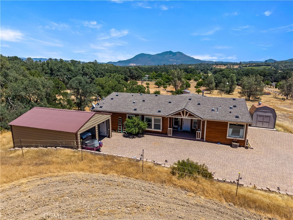 Beautiful Equestrian Ranch! Walk into you foyer and be welcomed to breathtaking views right from the expansive windows along living room. Turn left and enter the primary suite. Here you will find your self nestling into bed with views from every window, a sitting area, a large walk in closet, and huge master bath! With double sinks, walk in shower and don’t forget about the tub or private deck! Entering back into the foyer you will be looking into your large open kitchen, with a big island and plenty of counter space for all the chefs in the house! Large cabinets, bar counter and all while taking in the outside view. Here you can enter the second wing to the second living room, two more bedrooms and second bath. Back out the kitchen you will be taken to the formal dining and living area with French doors right out to the deck. To the left down the hallway you will find the third bath on the right, large laundry room with deck access on the right and straight down the fourth bedroom. That was just the home! 3/4 of the property has been fenced and crossed fenced with. A 4 horse barn and tack room with office, a 39 x 60 ft Quonset, 171 x 123 ft equestrian arena, multiple paddocks on the property and water and power hook up for RV! Two sides of the property are neighboring County Water Resources land, allowing 3200 acres of hiking, disc golf, horse trails and more! Welcome Home!