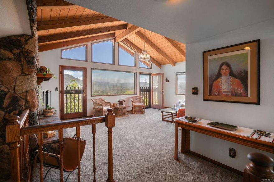 Views! Views! Views!  This property sits high atop a hill with panoramic views across the entire valley.  There are views out of every window in the home.  An A Frame wood ceiling greets you in the main living room with large windows that overlook the valley and trees.  There are large stone fireplaces in both the living room and bonus/den room.  Many avocado trees are throughout the property and there is plenty of space for a pool, garden and animals.  Please refer to Part Three of the zoning ordinance for info regarding horses and animals allowed.  There are 3 acres of space that are just waiting for your creative ideas.  This is truly a diamond in the rough and someone can make this their compound with unmatched privacy at an unmatched price!