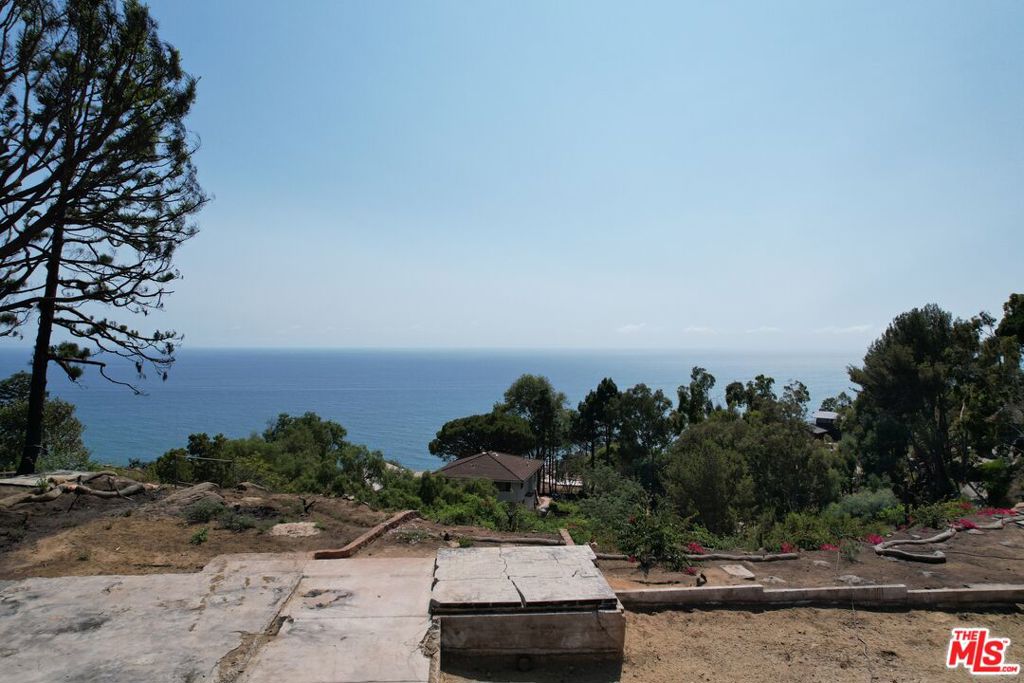 Set on a quiet cul-de-sac in one of Eastern Malibu's most coveted neighborhoods, this Big Rock rebuild opportunity offers a savvy buyer the chance to build their dream home on a prime parcel with sweeping views of the Queen's Necklace and Catalina Island - all just 15 minutes from Cross Creek and 20 minutes from Santa Monica. The nearly 0.9-acre lot, once home to a 2,224 SF residence lost in the recent fire, comes with proposed like-for-like plans that call for a 2,352 SF home with a 649 SF garage and more than 2,100 SF of outdoor deck space, providing the perfect foundation for a custom Malibu retreat. Perched where Big Rock meets the mountain peak, this oasis features permanently unobstructed panoramic views, clear of any future construction. Experience the ever-changing sea and sky in complete privacy and free from traffic noise, while enjoying the rustic charm of Big Rock and its small-town feel. This property showcases the best of both worlds, delivering an exceptionally exclusive Malibu lifestyle that feels like a hidden escape while remaining just minutes from the area's best dining, shopping, and beaches. Outdoor enthusiasts will also appreciate nearby access to thousands of acres of parkland with some of the region's most secluded hiking trails. The best of Malibu living awaits - seclusion, views, and convenience in one remarkable setting.