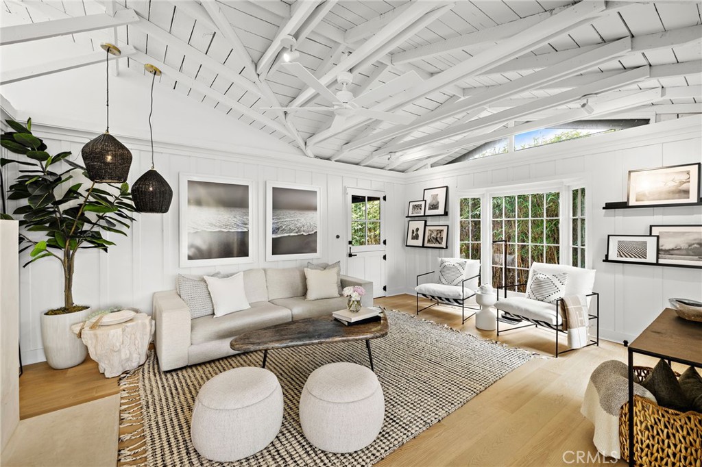 Stunningly Remodeled and Beautifully Furnished Coastal Retreat in the Heart of Laguna Beach. Experience the epitome of coastal living in this beautifully remodeled 1926 cottage, ideally situated in Laguna Beach’s coveted Woods Cove neighborhood—just moments from the ocean and the beloved Bluebird Canyon Park. This charming and historic home offers a serene escape, perfectly blending timeless character with luxurious modern updates. Set on a picturesque corner lot, this fully furnished residence features three spacious bedrooms, each with its own en suite bathroom, plus an additional half bath for guests—providing both comfort and privacy for all. The primary suite showcases a Tulum-inspired spa bathroom, and a luxurious soaking tub highlighted by a striking 10-foot skylight that fills the space with natural light and tranquil energy. Throughout the home, refined design details abound, including Carrera marble countertops, custom window treatments, high-end heated bedding, recessed lighting, automated blinds, ceiling fans, and vaulted ceilings adorned with skylights and transom windows. The inviting living room—centered around a contemporary fireplace—flows effortlessly into both front and rear outdoor living spaces, the indoor and outdoor dining areas, and a light-filled chef’s kitchen with an ocean view deck. The modern bathrooms feature Taj Mahal quartzite or marble counters, custom sinks, heated towel racks, all creating a harmonious indoor-outdoor flow that enhances the home’s peaceful ambiance. Outside, enjoy mature shade trees, lush landscaping, multiple covered porches, an ocean view deck, a built-in sun bench, a luxury ping-pong table, and multiple stylish dining areas with a built-in BBQ—perfect for entertaining or unwinding under the stars. Classic Dutch doors welcome guests into a bright and airy environment, defined by white-paneled walls, fresh coastal decor, and an undeniable sense of tranquility. This exceptional home is the perfect setting for a dream vacation—offering timeless charm, modern sophistication, and an ideal location to enjoy the very best of Laguna Beach.