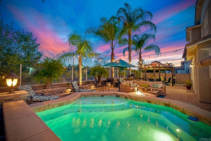 REDUCED PRICE!  MOTIVATED SELLER!  Exquisite Luxury Living in Harveston, Temecula   Welcome to unparalleled elegance in the prestigious Harveston community of Temecula, California. This magnificent 4-bedroom, 4-bathroom residence spans 3,675 square feet, making it the largest and most luxurious home in the development. Built in 2006 and thoughtfully upgraded, this two-story masterpiece blends modern sophistication with family warmth.  A custom front porch with stately pillars and ambient LED lighting greets you. Inside, soaring 9-foot ceilings on both levels (a rare feature in this community) and expansive, naturally lit interiors await. Freshly painted walls, rich laminate wood floors, elegant crown molding, and wood shutters on 38 rescreened windows enhance the home's charm.  The recently remodeled gourmet kitchen boasts top-of-the-line new appliances, pull-out drawers in custom cabinets, and new LED lighting. Adjacent are the upgraded pantry and laundry room. The open-concept design connects the kitchen to a spacious family room with a built-in entertainment system and cozy gas fireplace. A formal dining area awaits special occasions.  Upstairs, retreat to the luxurious master suite featuring a huge walk-in closet and custom storage with chic barn doors. The master bathroom offers upscale finishes, new LED lighting, and a new frameless shower door. Additional living spaces include a downstairs guest bedroom with full bathroom, an upstairs office perfect for remote work, a large bonus room complete with a pool table, and a downstairs den.  Step outside to your resort-style backyard—a private oasis designed for relaxation and entertainment. Enjoy the cocktail swimming pool and jacuzzi with an integrated firepit, custom lighting, pavers, a charming gazebo, and a built-in BBQ island. The 6,098 square foot lot includes six fruit trees—lemon, white nectarine, and fig—offering delightful homegrown produce.  Modern conveniences abound with 20 solar panels under a transferable lease, generating 11,000 kilowatts per year at a fixed rate of $149 per month, ensuring energy savings. A whole-house fan and water filtration system enhance comfort. The three-car tandem garage features new door springs, a quiet opener, ample storage with cabinets and overhead units, and an RV 30amp hookup.  Located within the highly sought-after Harveston community, HOA dues of $133 per month provide access to exceptional amenities: a sparkling pool with a new $500,000 splash zone for children, cabanas, umbrellas, spa, community clubhouse, barbecue and picnic areas, biking and hiking trails, jogging track, playgrounds, and serene sidewalks. The picturesque lake offers paddle boats and fishing, enhancing the outdoor experience.  Minutes from shopping centers, gourmet restaurants, and Temecula's renowned wineries, with easy access to major highways to San Diego and Los Angeles. Families will appreciate the excellent schools within the Riverside County district.  This meticulously maintained property offers more than a home—it’s an upgraded lifestyle. Don't miss this rare opportunity to own a piece of paradise in Harveston. Schedule your private tour today and experience the unparalleled luxury and charm of this magnificent home. Your dream lifestyle awaits.