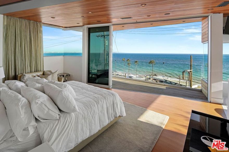 By the award-winning PAA Studio, this architectural offers explosive panoramic ocean & coastline views from nearly every room. Upon entry, guests are greeted by an open great room and modern chef's kitchen featuring Miele & Sub-Zero appliances, stone counters, and a large center island. Floor- to-ceiling glass doors give way to an enormous deck/lounge overlooking the glorious Santa Monica Bay. Organic elements such as wood ceilings, White Oak hardwood floors & a unique geometric staircase promote warmth within a contemporary design. Up the floating stairs or elevator, the unrivaled indoor-outdoor master suite occupies the entire top level; featuring pocket glass doors that run the length of the entire private balcony, an incredible walk-in closet & a spa-like bath with a huge soaking tub & oversized shower. The lower level features a media & billiards room. This architectural tour de force defines sophisticated California living with unparalleled commanding views.