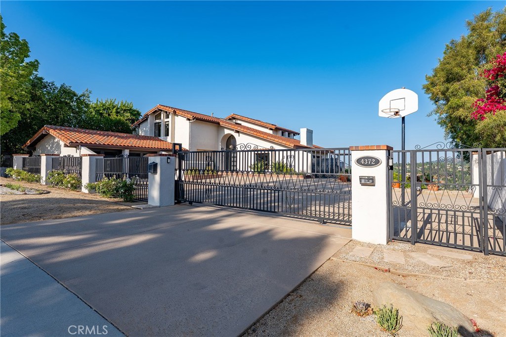 Nestled at the end of a cul-de-sac, on one of the most coveted streets in Calabasas Park, come see this updated, custom home with 4 bedrooms, 4 and 1/2 bathrooms, Office, and 180 degree city-view light. The VIEW captures the sunrise in the mornings and city-lights in the evenings.
Designed as the original builder's personal home, this home has an arched entry, custom-stair banister, an open-wood beamed ceiling in the living, unique-aged espresso floors, new black-trimmed LED lighting, a built-in refrigerator, Thermador double-oven and more. Outside enjoy the eco-friendly landscaping, an oversized driveway that accommodates 6 cars, and security gates.
Additionally, you will enjoy every aspect of the backyard-from the Custom BBQ Area and shaded pergola, to the large deck where you can show movie on the back of the house or stare out into the night. Plenty of space for entertaining any size group.
Back inside, enjoy the view from the dining room, kitchen, living rooms(2) and Primary Suite. ALL bedrooms are ensuite. The Primary bathrooms plus the upstairs bathrooms were recently updated with stone-coated counters black fixtures, luxury tile floors, and solid wood doors. This home is a quality home with warm and inviting touches. 4 ensuite bedrooms, 1 lower office/living space with separate entry, plus views, pool, jacuzzi and deck.
