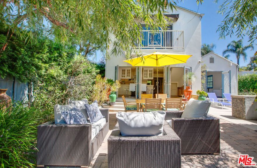 Ready for move-in mid-October. Nestled in a private, gated enclave, this fully furnished West Hollywood sanctuary offers a blend of luxury and comfort. The expansive 3-bedroom main house features a grand living room with elegant hardwood floors and a commanding fireplace, creating a warm and inviting atmosphere. This spacious area seamlessly flows into an open, airy kitchen with glass-paned doors that lead to a serene backyard, perfect for al fresco dining. Step outside to enjoy the beautifully designed patio, complete with a built-in grill and a refreshing lap pool. A charming, fully independent 1-bedroom guesthouse adds versatility to the property, making it ideal for visitors or additional living space. The generously sized bedrooms include a remarkable primary suite with an ensuite bathroom and a private balcony that spans the entire second floor, offering a tranquil retreat. Conveniently located near local treasures like the Beverly Center, Urth Caffe, and the vibrant shops of Melrose Avenue, this home provides an exceptional West Hollywood living experience.